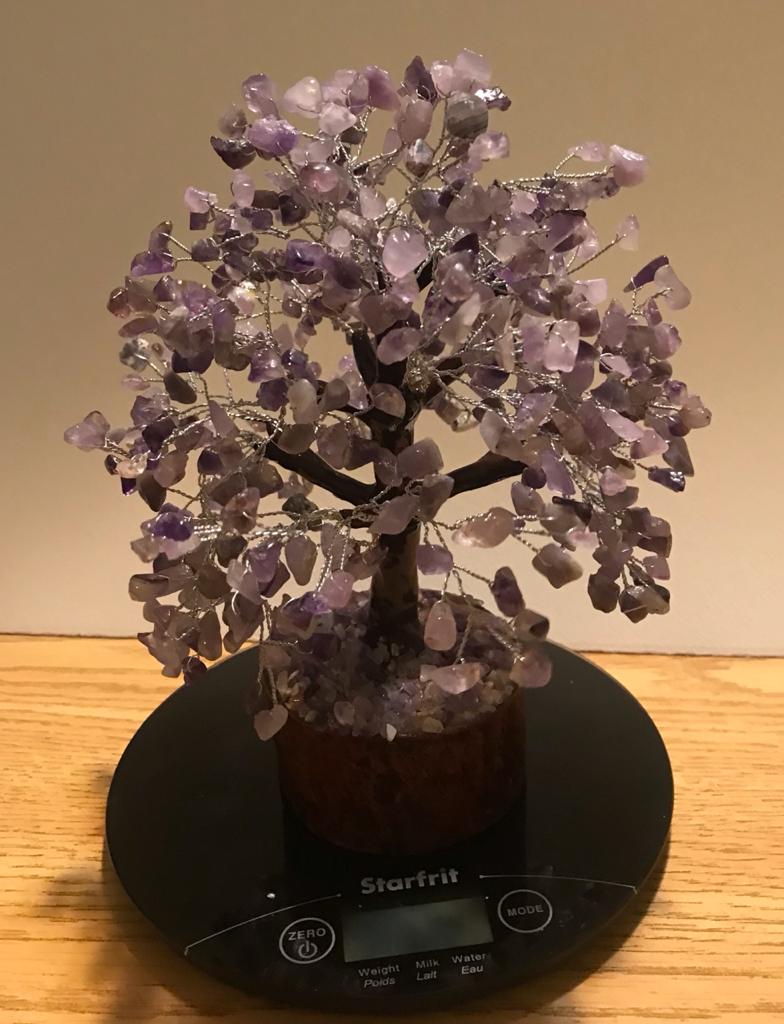 A beautifully crafted Amethyst Gemstone Tree made of 500 natural amethyst chips on silver wire, standing 9 inches tall.