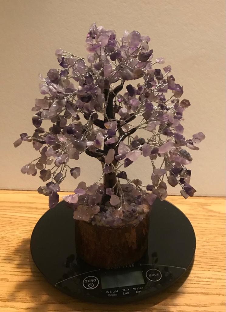 A beautifully crafted Amethyst Gemstone Tree made of 500 natural amethyst chips on silver wire, standing 9 inches tall.