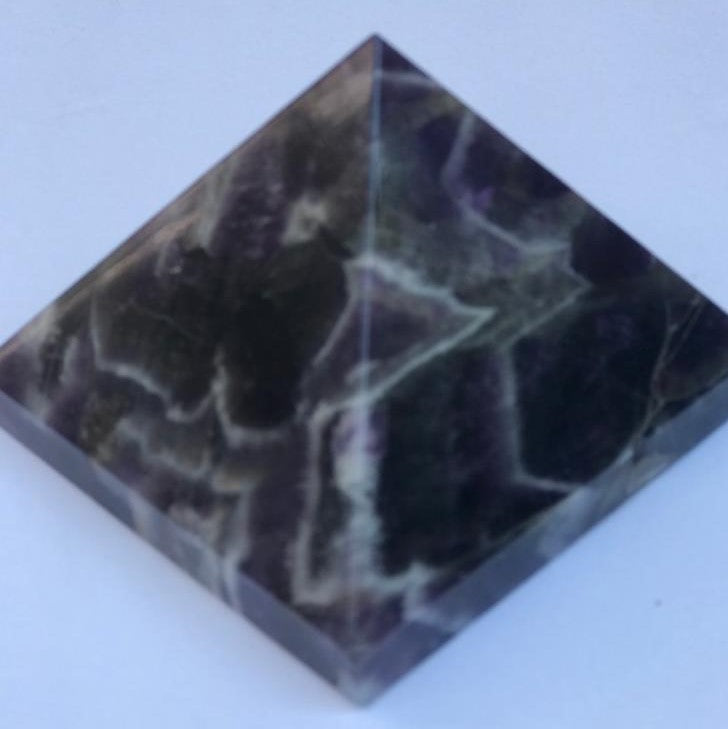 Hand-carved natural Amethyst Pyramid, 3 x 3 inches, showcasing unique color and texture variations.