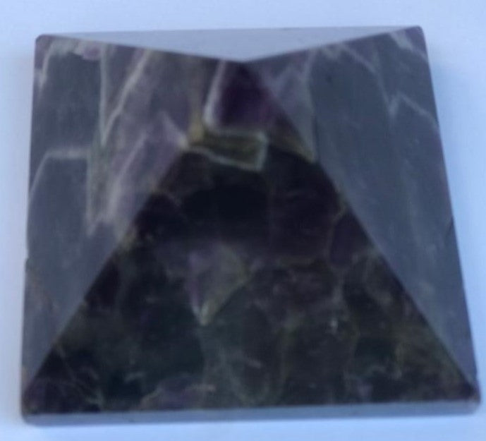 Hand-carved natural Amethyst Pyramid, 3 x 3 inches, showcasing unique color and texture variations.