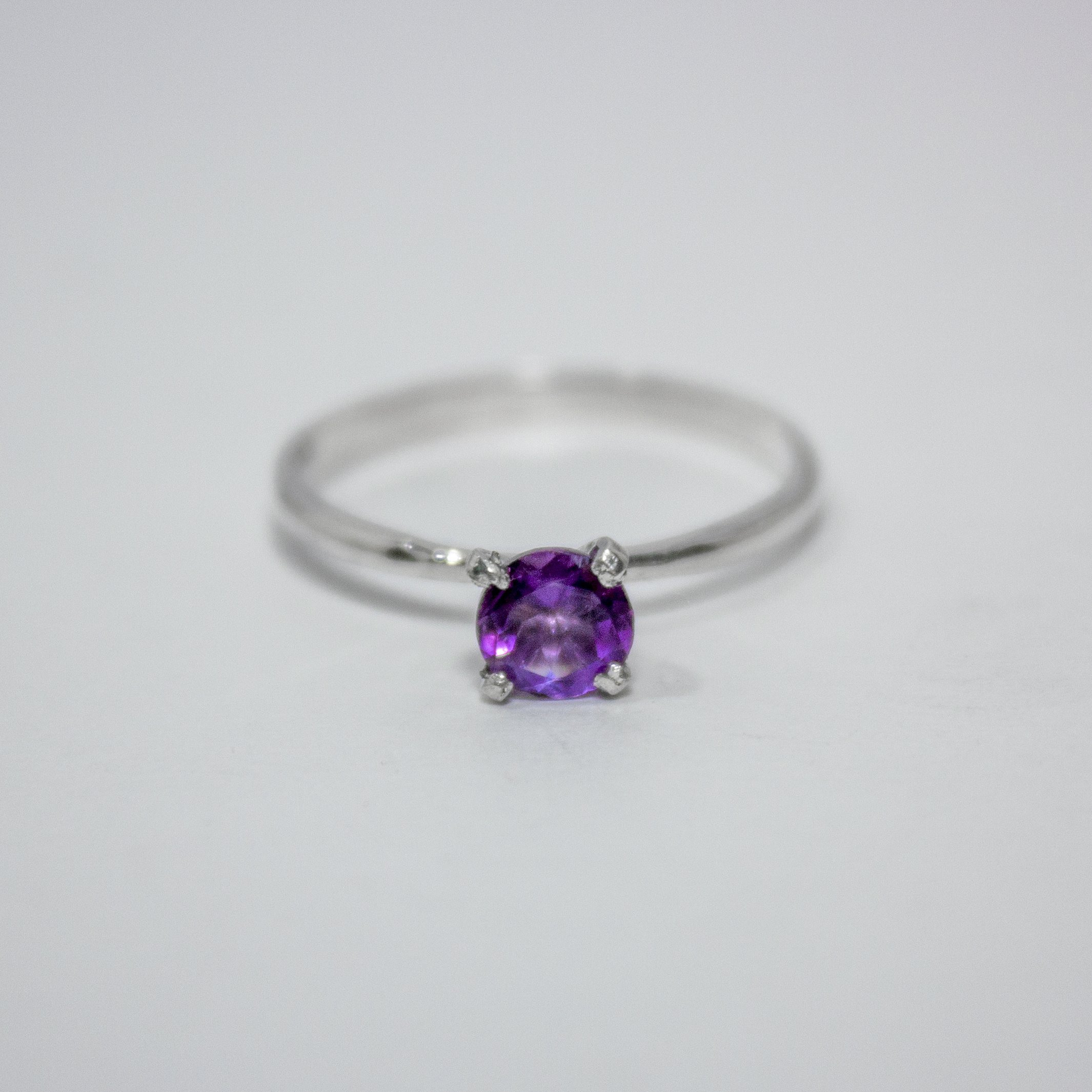 Amethyst Solitaire Sterling Silver Ring featuring a vibrant purple amethyst set in a sleek sterling silver band.