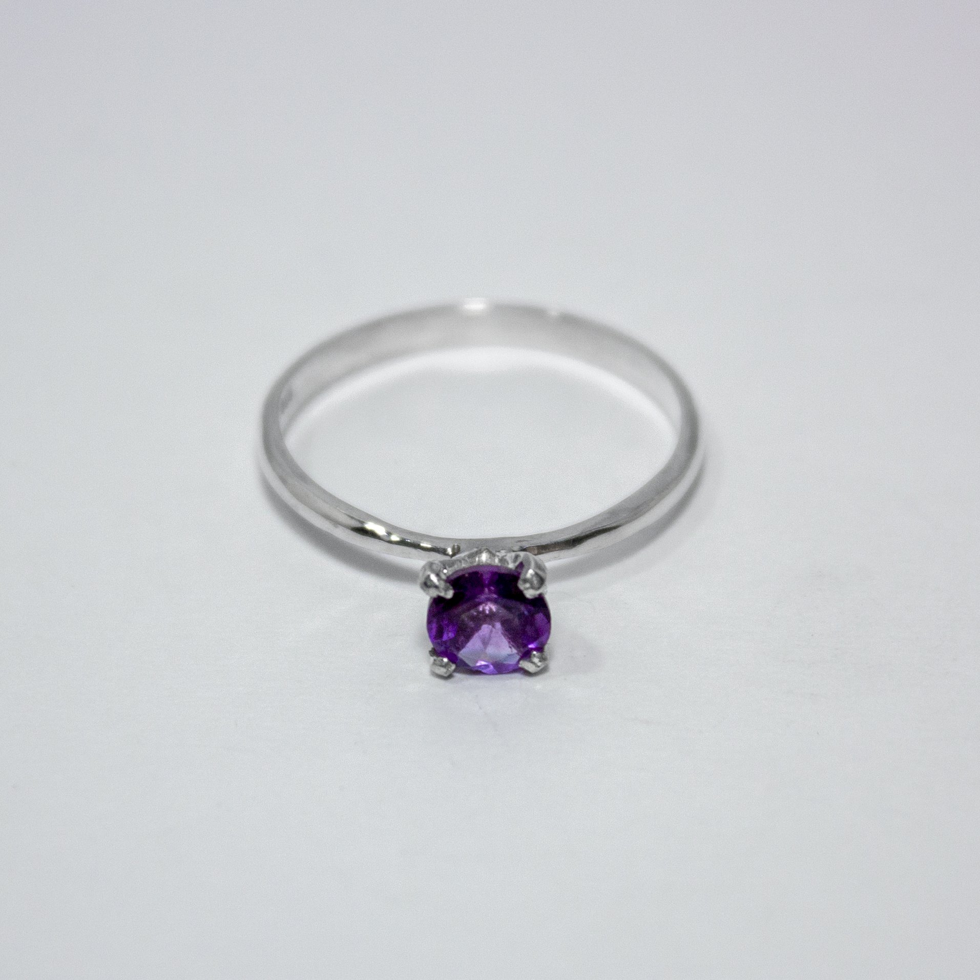 Amethyst Solitaire Sterling Silver Ring featuring a vibrant purple amethyst set in a sleek sterling silver band.