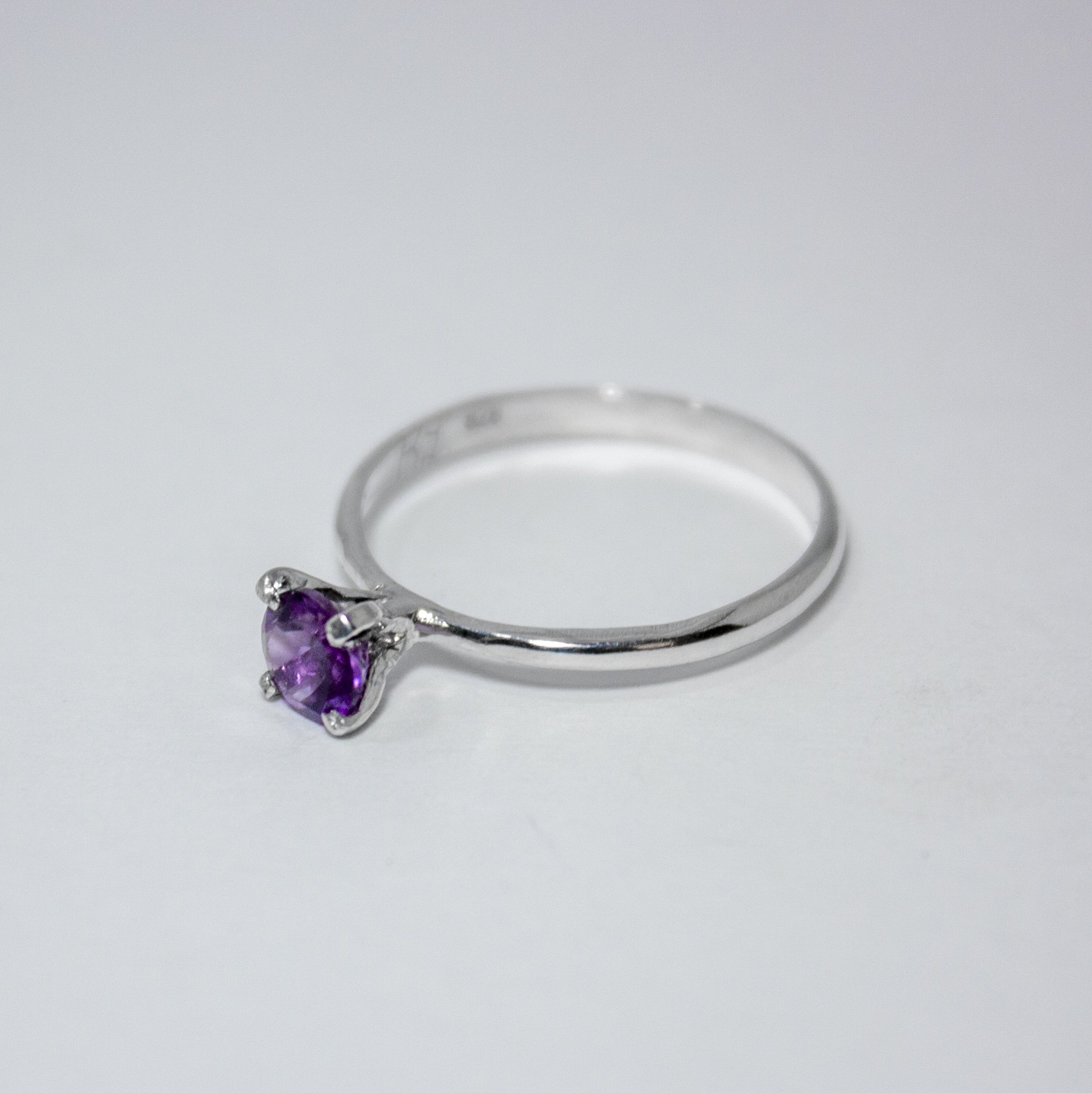 Amethyst Solitaire Sterling Silver Ring featuring a vibrant purple amethyst set in a sleek sterling silver band.