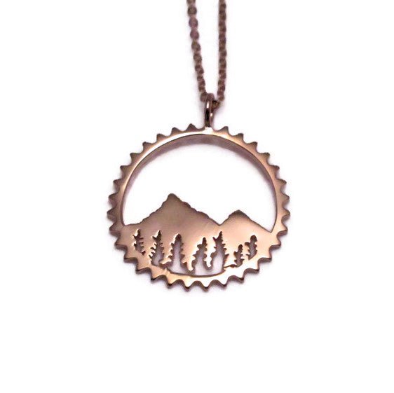 Amore Mountain Necklace featuring a sterling silver mountain design in a chain ring, symbolizing biking adventures.