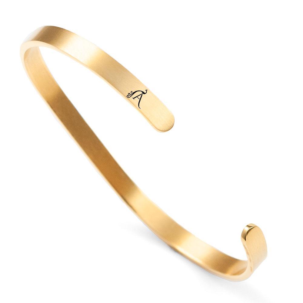 A dainty 'Amour' cuff made of stainless steel with an 18K gold plated finish, elegantly designed to symbolize love.