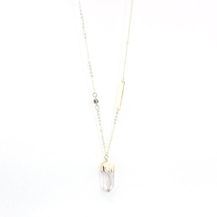 A beautifully handmade quartz pendant necklace with gold plated accents, showcasing a lengthy chain and sparkling details.