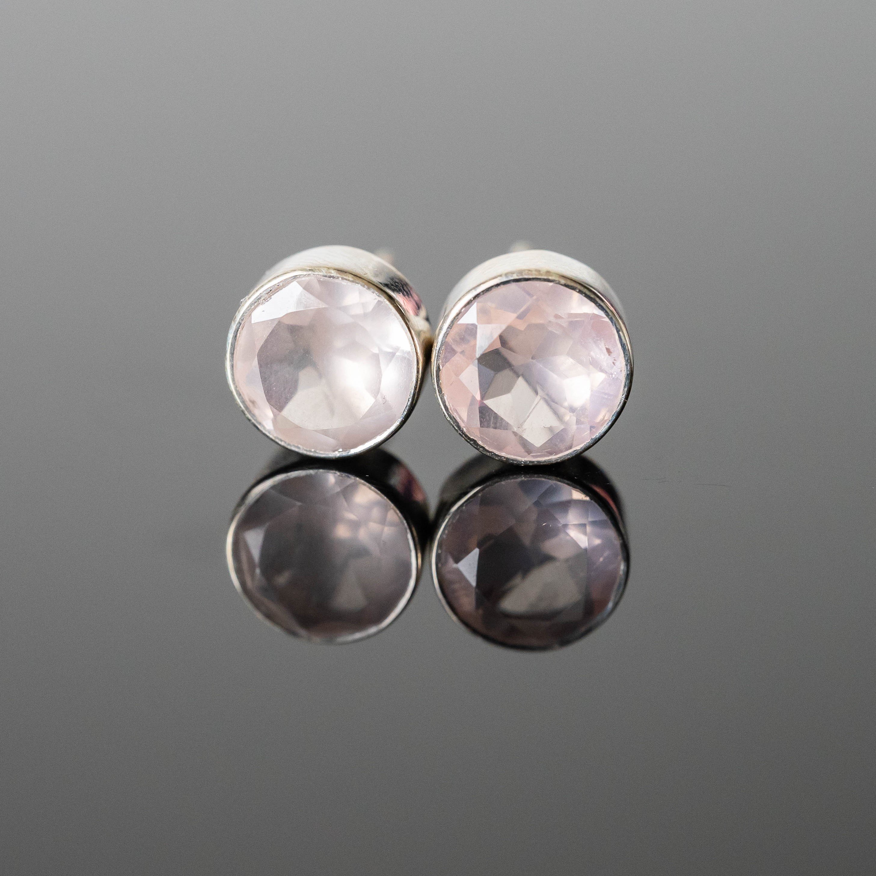 A pair of elegant Amy Rose Quartz Round Studs made from 925 sterling silver with 8 mm rose quartz stones, showcasing their unique handmade quality.