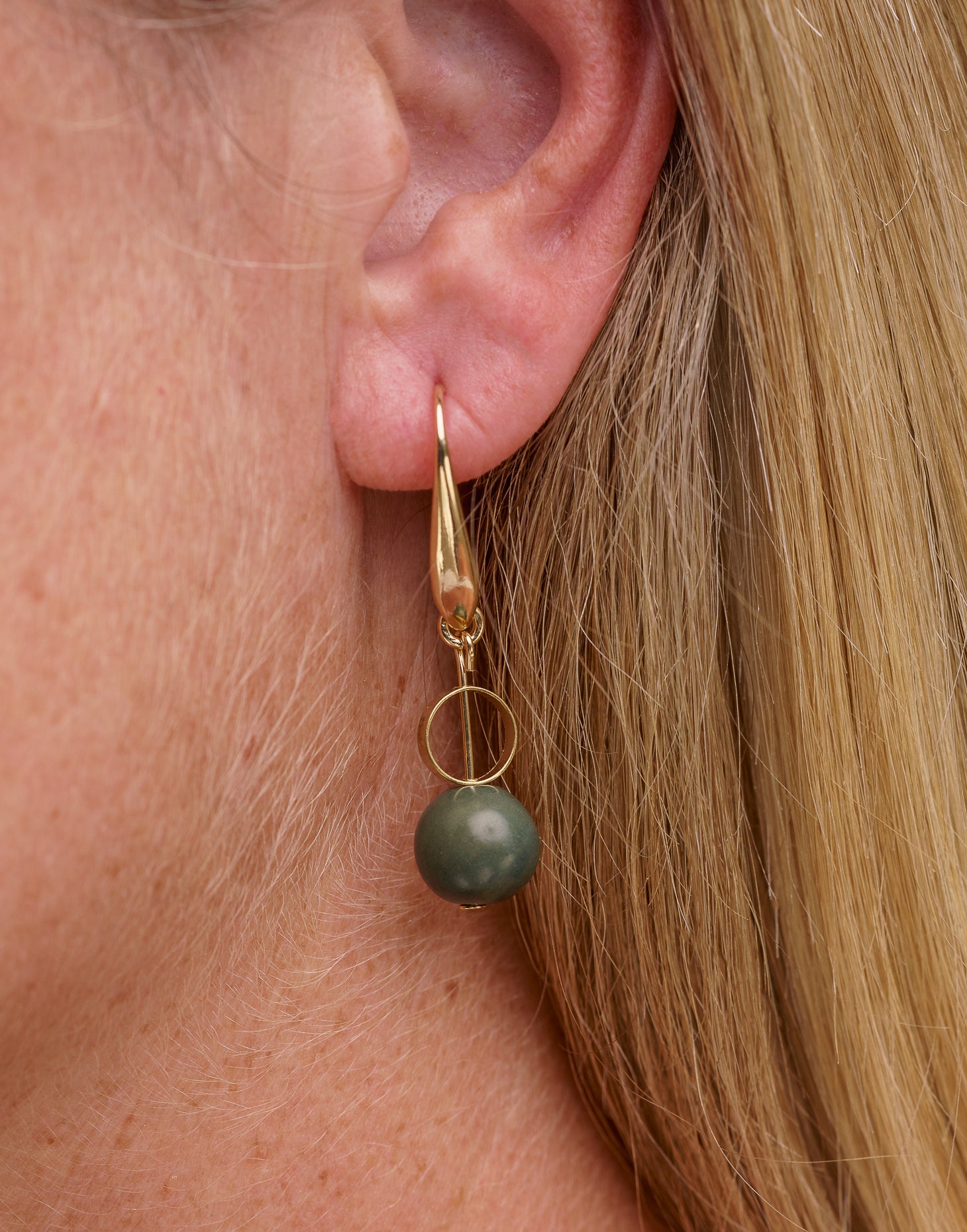 Ana Acai Earrings featuring pearl-sized acai seeds and brass hoop details, showcasing their unique and eco-friendly design.