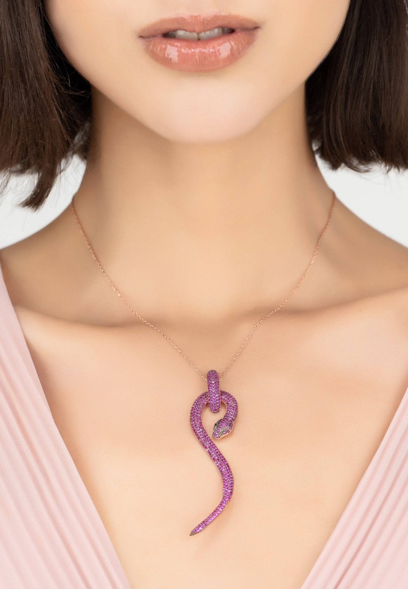 Anaconda Snake Pendant Necklace in rosegold with ruby zircons, showcasing intricate design and luxurious materials.