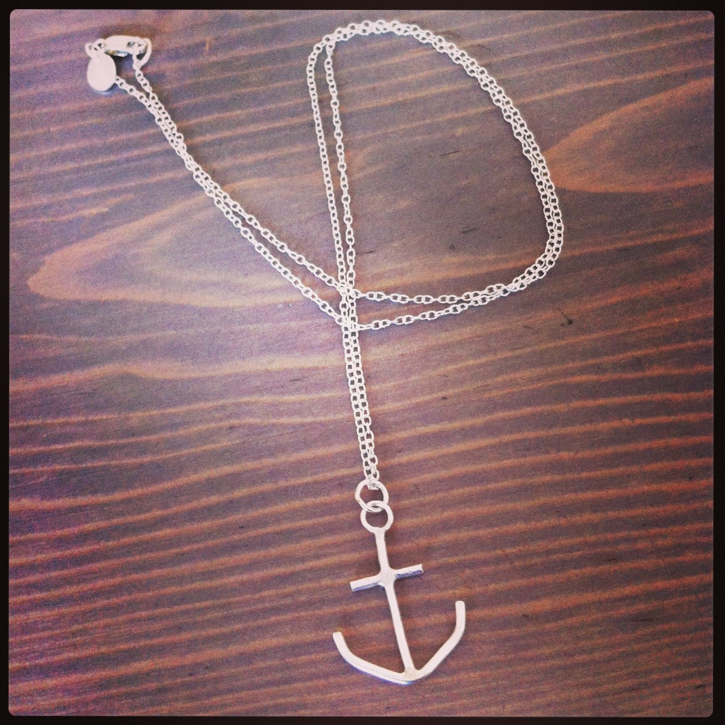 A handcrafted anchor necklace from The Forest & Sea Collection, symbolizing strength and courage, measuring approximately 21x21mm.