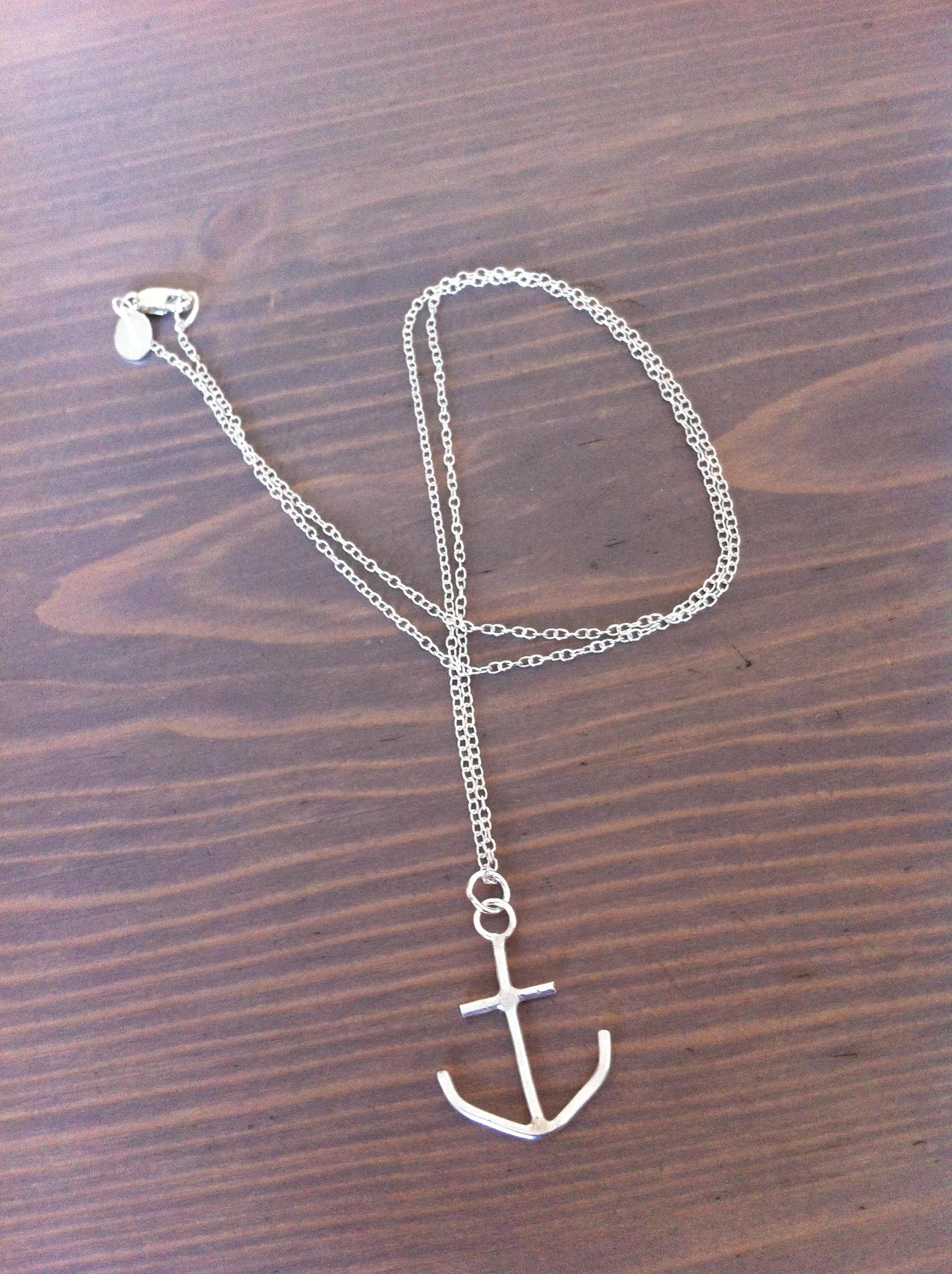 A handcrafted anchor necklace from The Forest & Sea Collection, symbolizing strength and courage, measuring approximately 21x21mm.