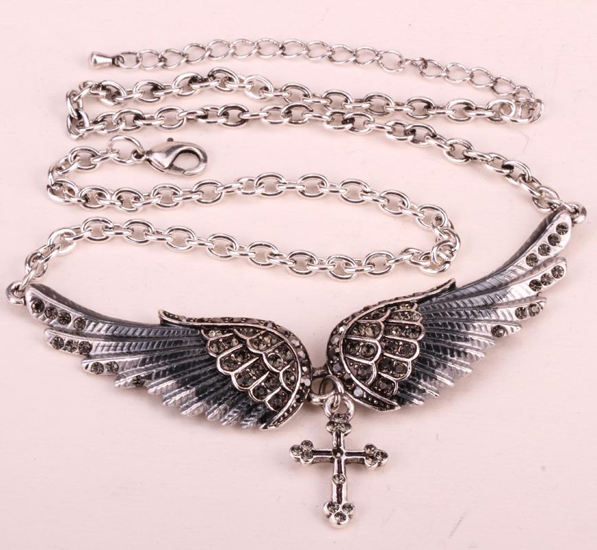 Angel Wing Cross Necklace Earrings Ring Set for women, featuring intricate designs in zinc alloy with crystal accents.