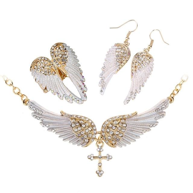 Angel Wing Cross Necklace Earrings Ring Set for women, featuring intricate designs in zinc alloy with crystal accents.