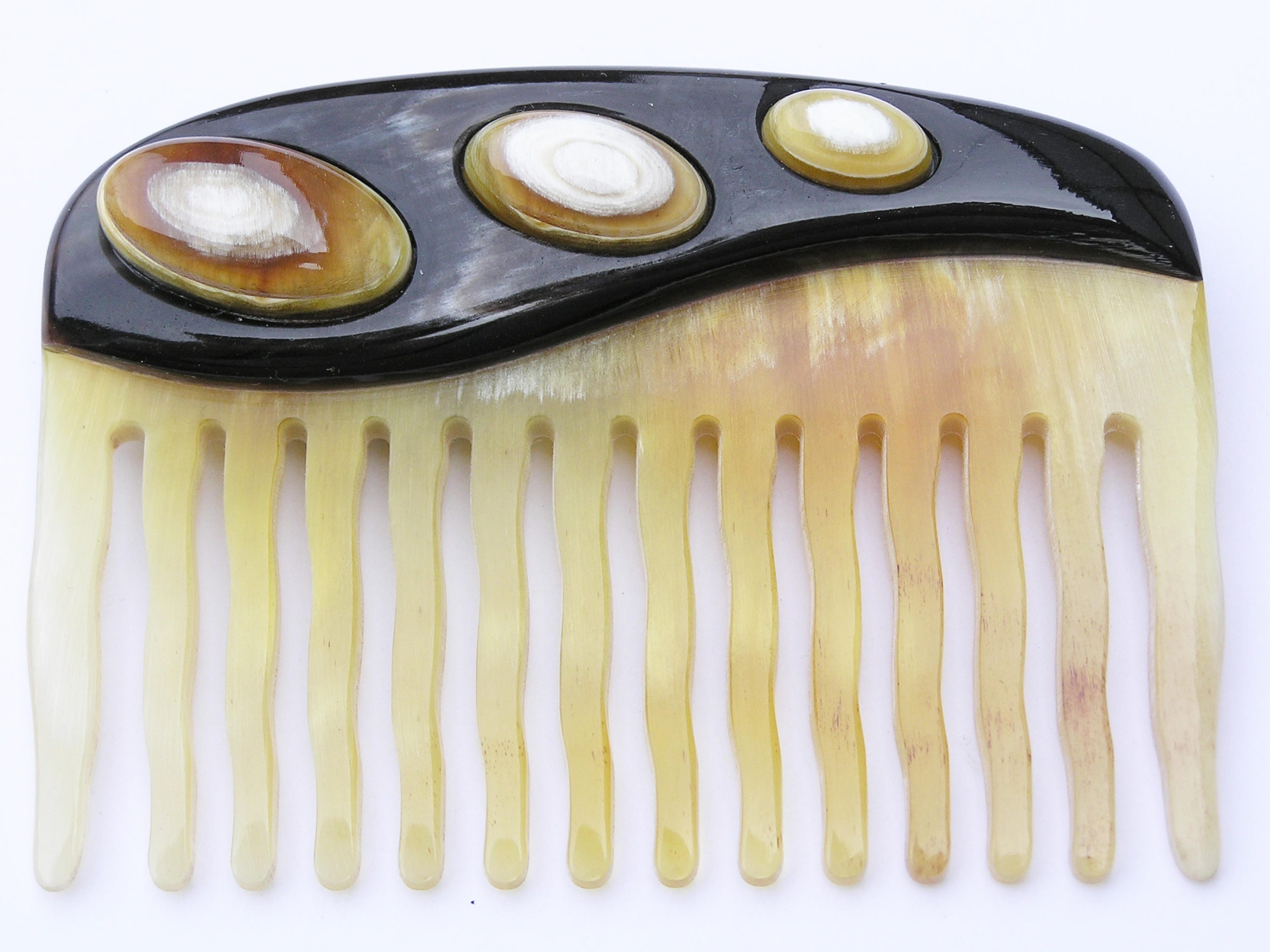 Elegant Anti Static Comb made from natural horn, featuring a unique design with contrast horn ovals and rounded tines for gentle combing.