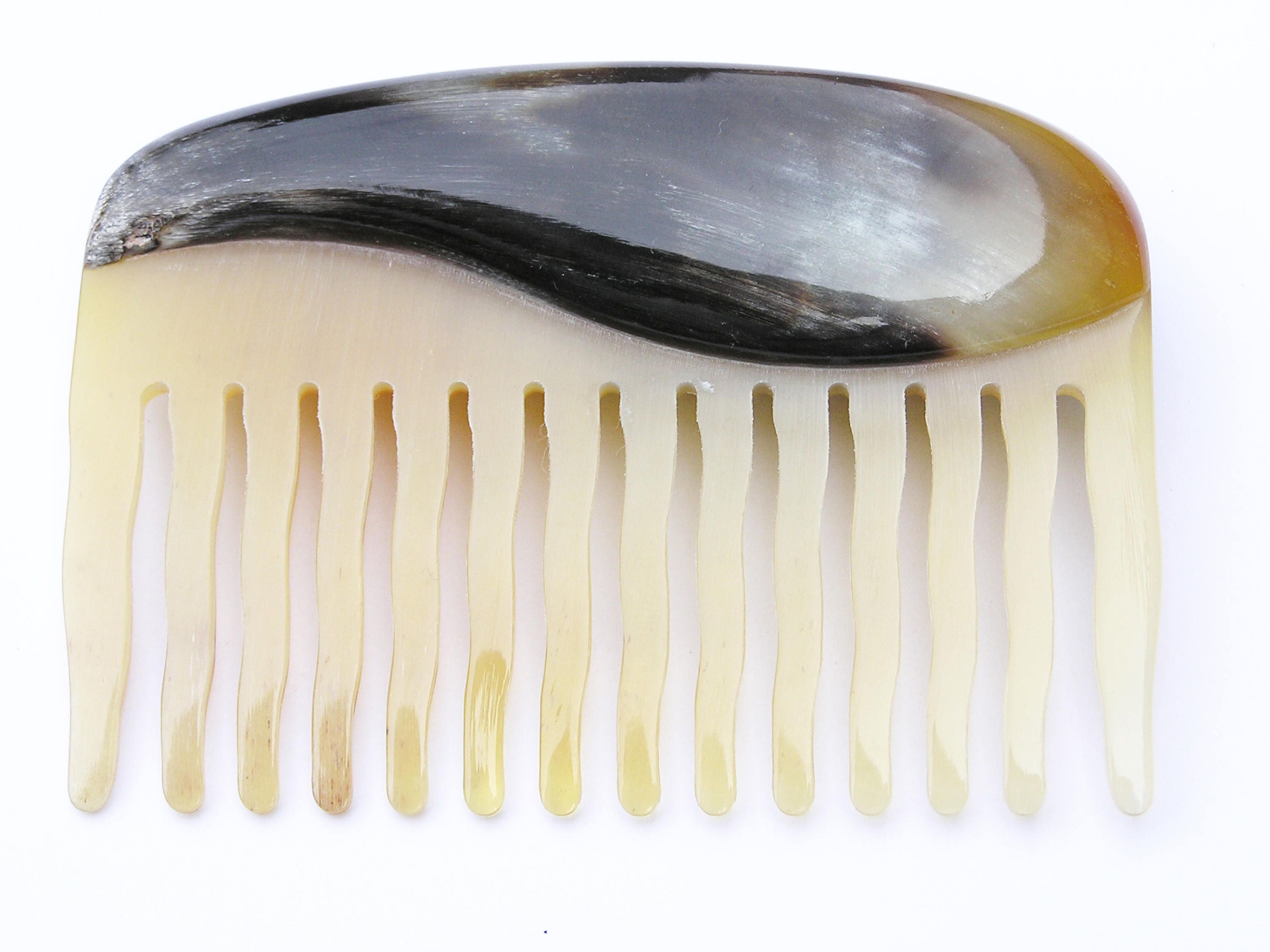 Elegant Anti Static Comb made from natural horn, featuring a unique design with contrast horn ovals and rounded tines for gentle combing.