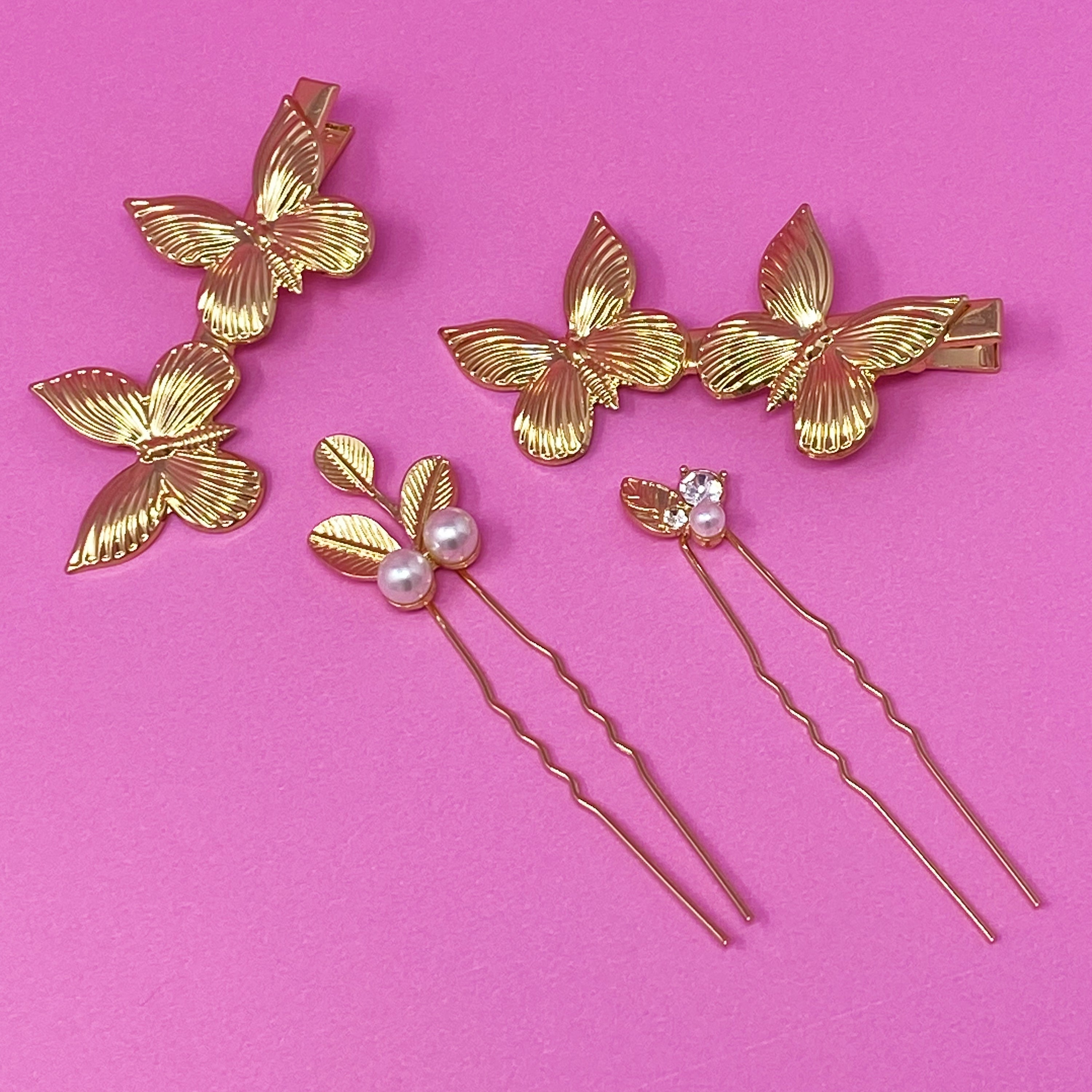 Antique Garden Hair Clip Set featuring two butterfly clips and two elegant pins with a golden finish, showcasing intricate details.