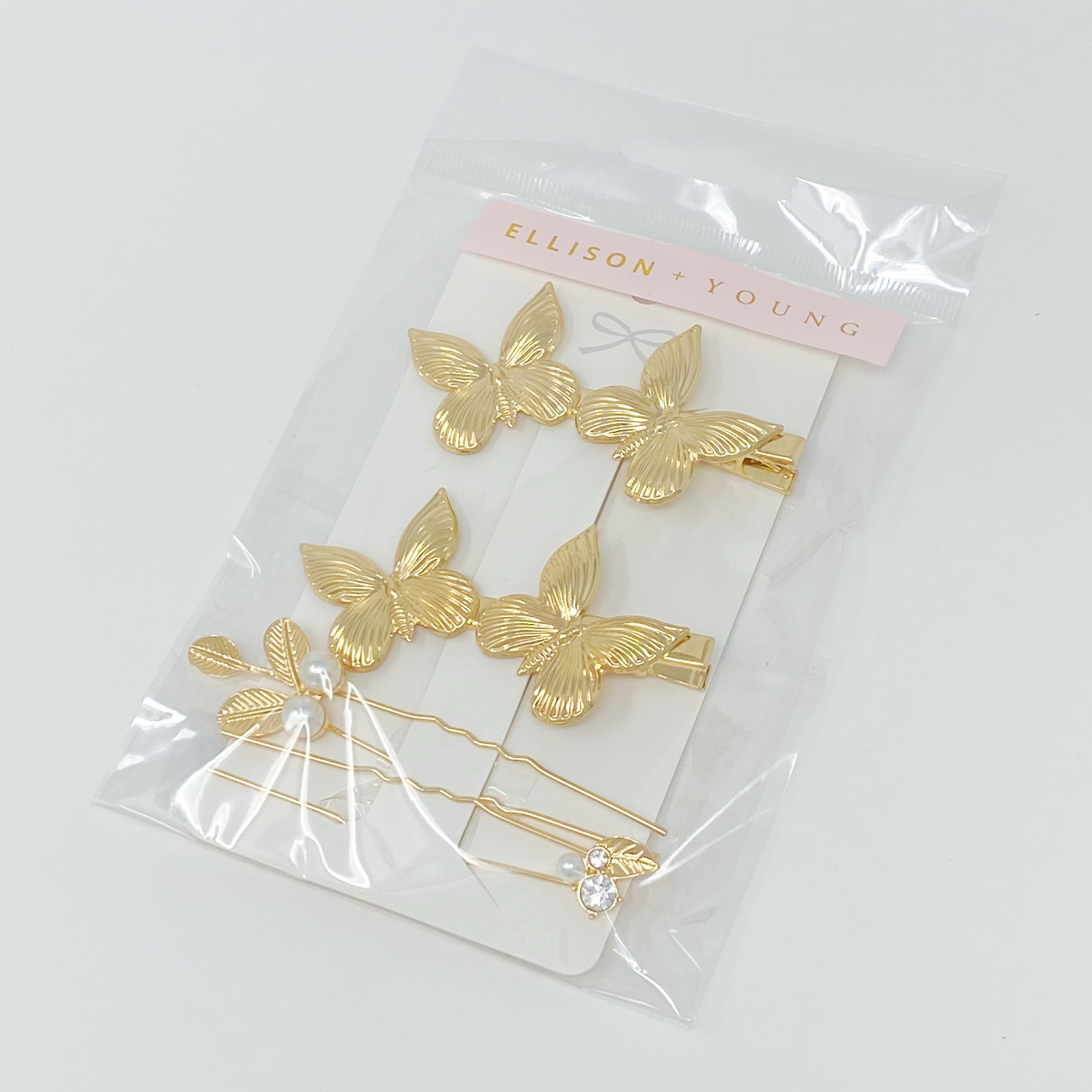 Antique Garden Hair Clip Set featuring two butterfly clips and two elegant pins with a golden finish, showcasing intricate details.