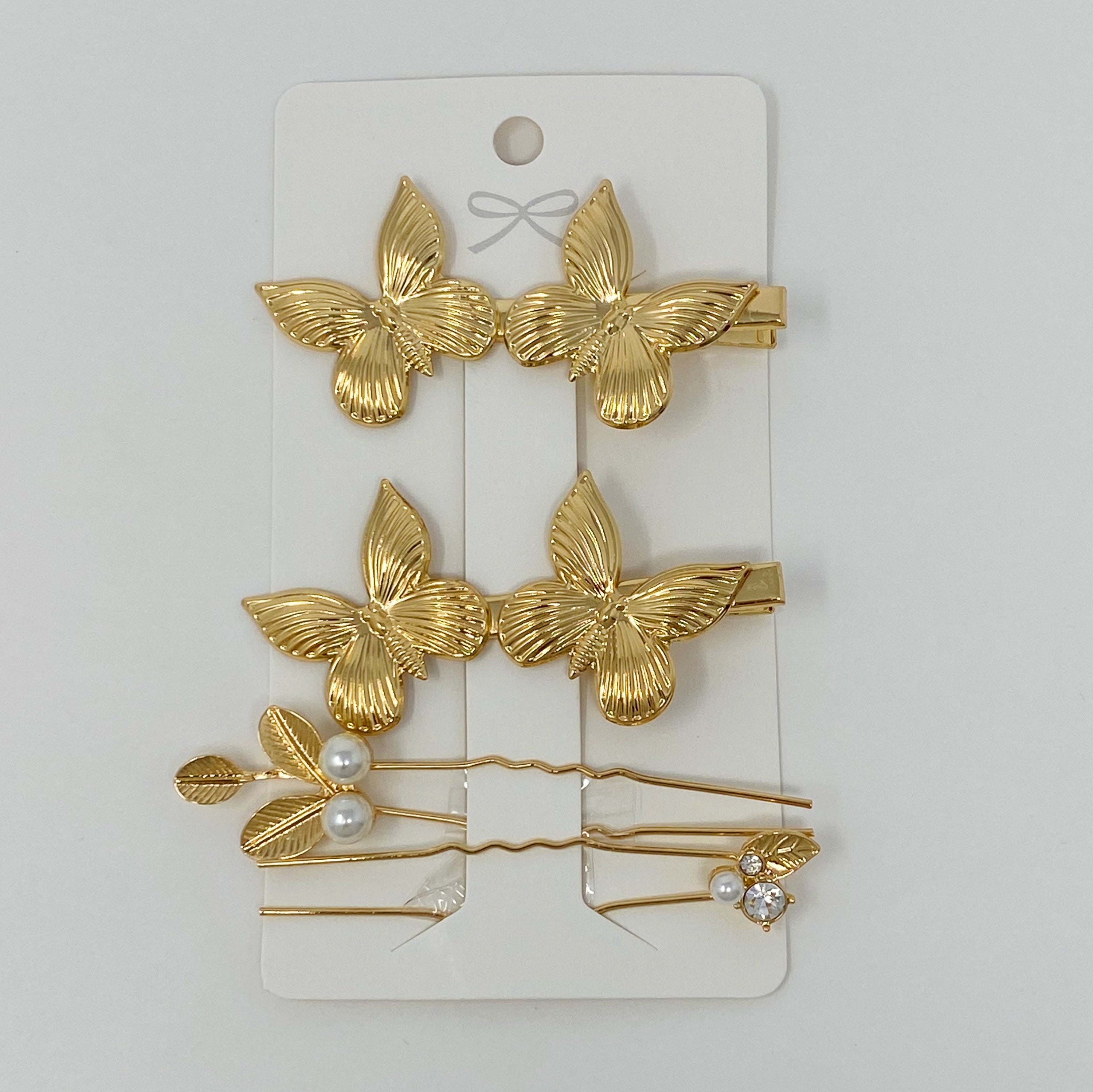 Antique Garden Hair Clip Set featuring two butterfly clips and two elegant pins with a golden finish, showcasing intricate details.