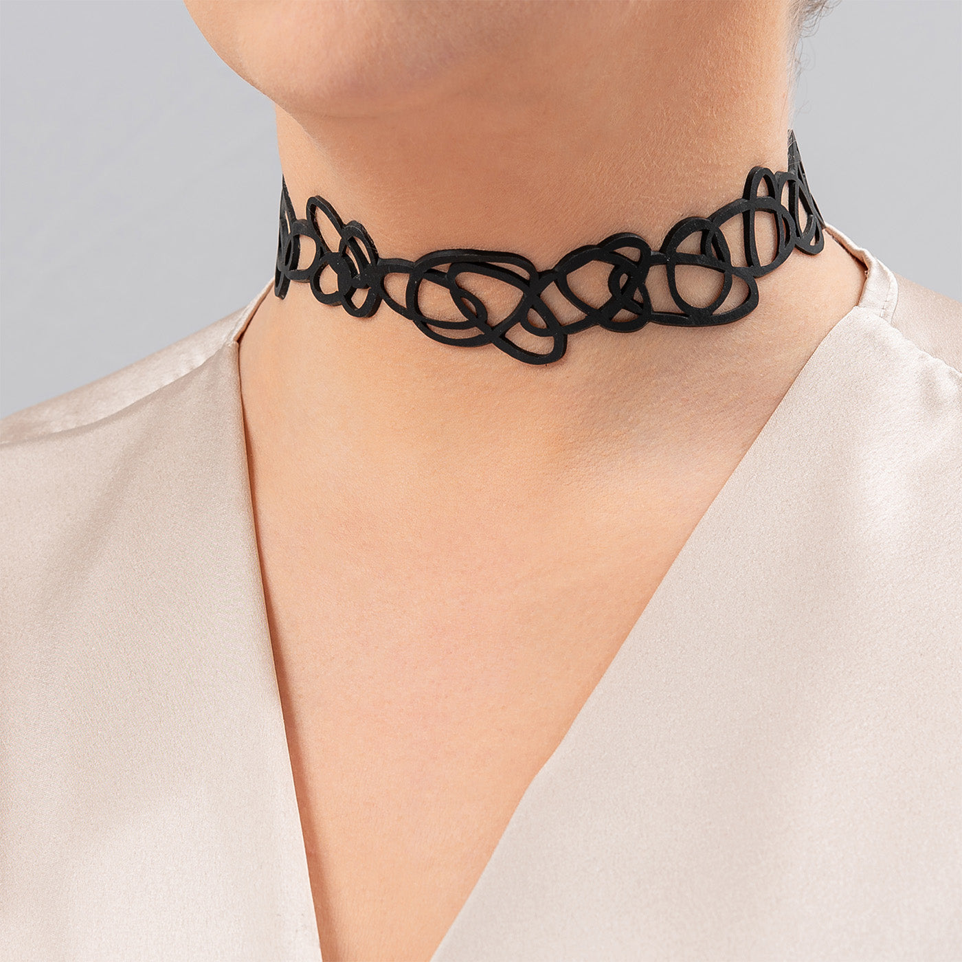 Apeiron Artistic Recycled Rubber Choker, handcrafted from reclaimed tyre inner tubes, featuring adjustable buttons and a bold design.