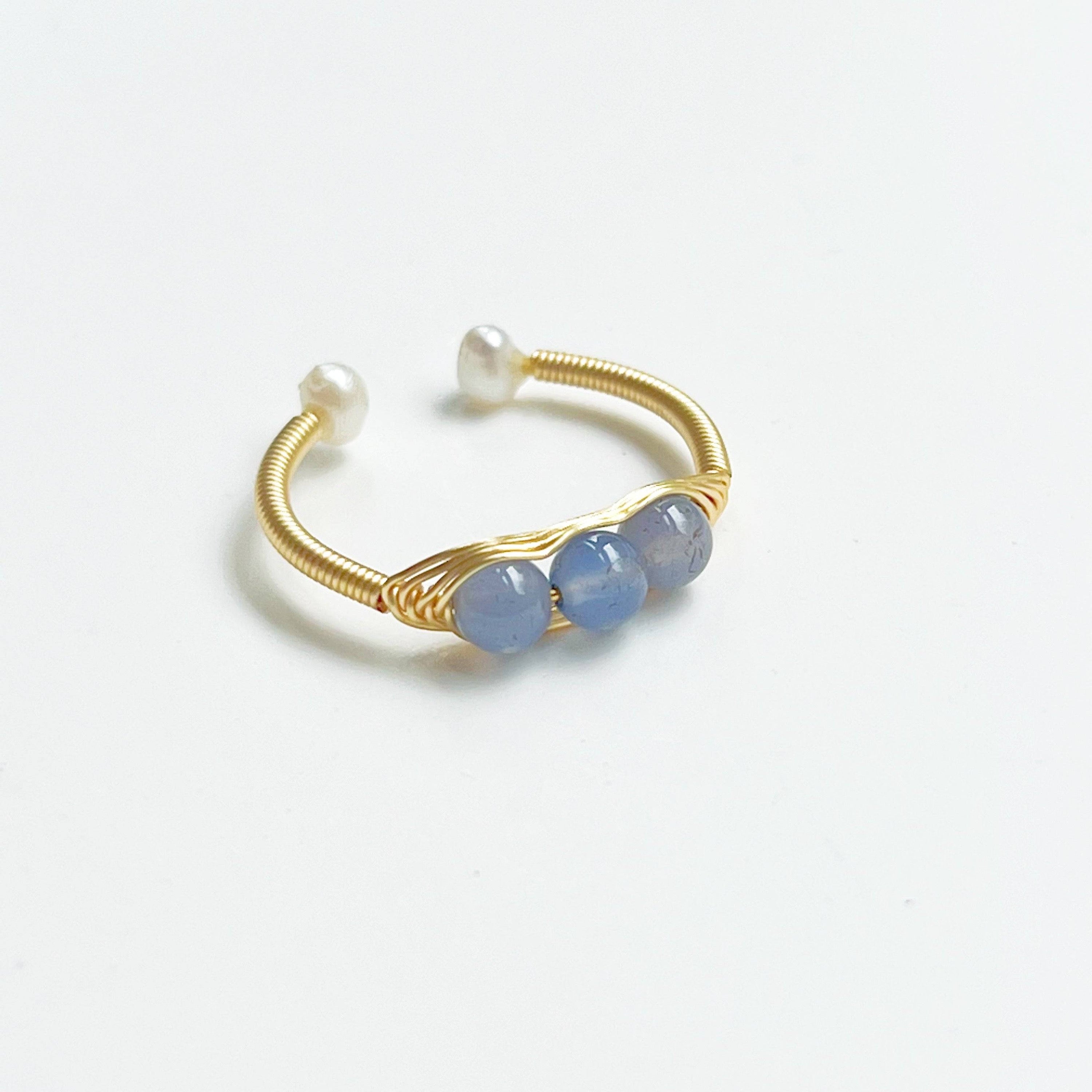 Aquamarine and Pearl Bead Adjustable Ring featuring three natural aquamarine beads on gold-plated bronze wire, showcasing its elegant design.