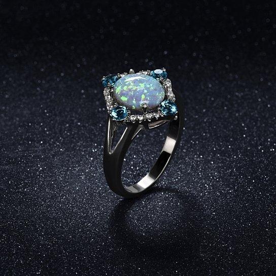 Aquamarine Opal Ring set in 18K white gold with cubic zirconia stones, featuring a halo design.