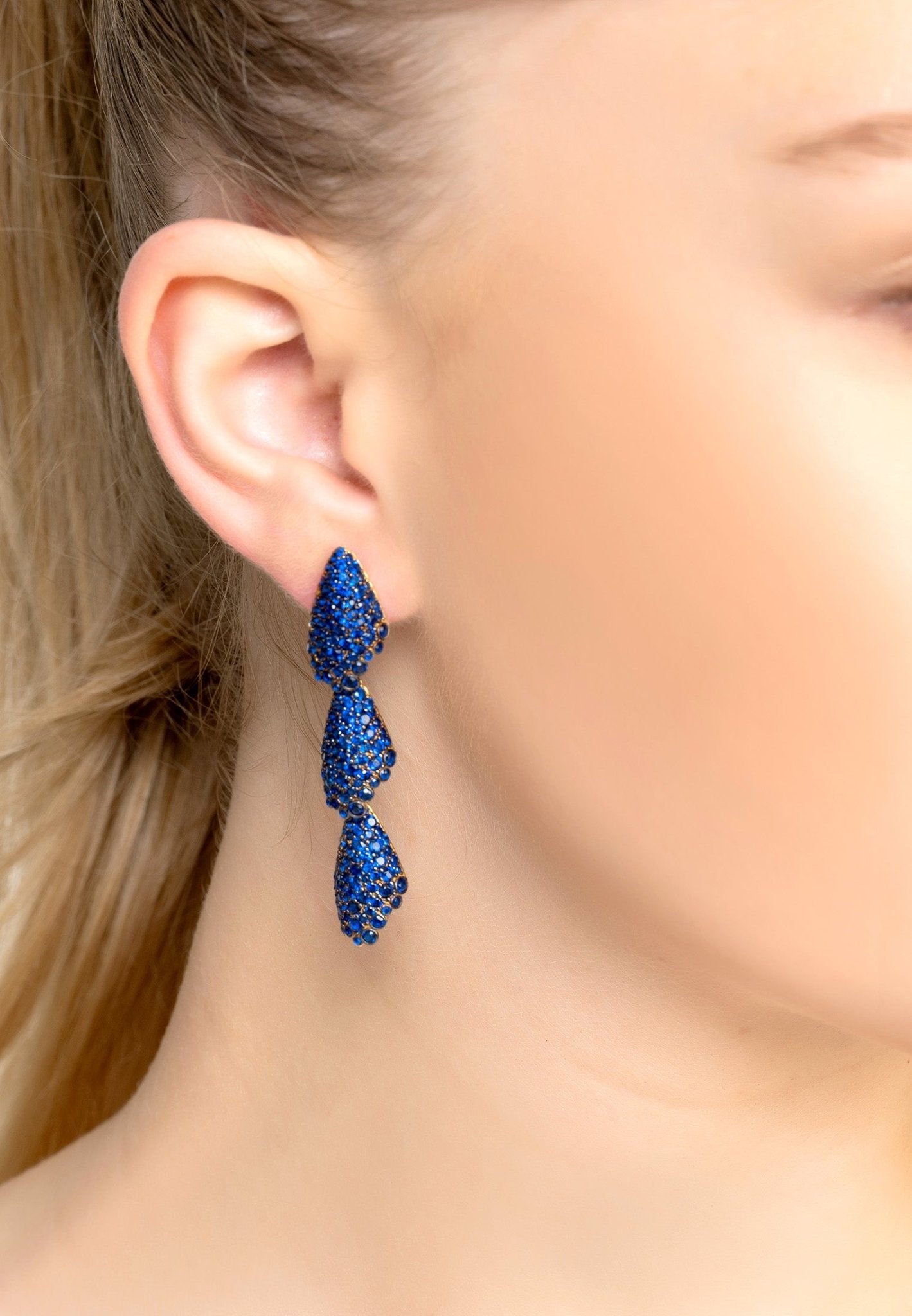 Arabelle Sapphire Blue Earrings Gold featuring cubic zirconia in a three-tiered shell design, elegantly crafted in sterling silver and gold.