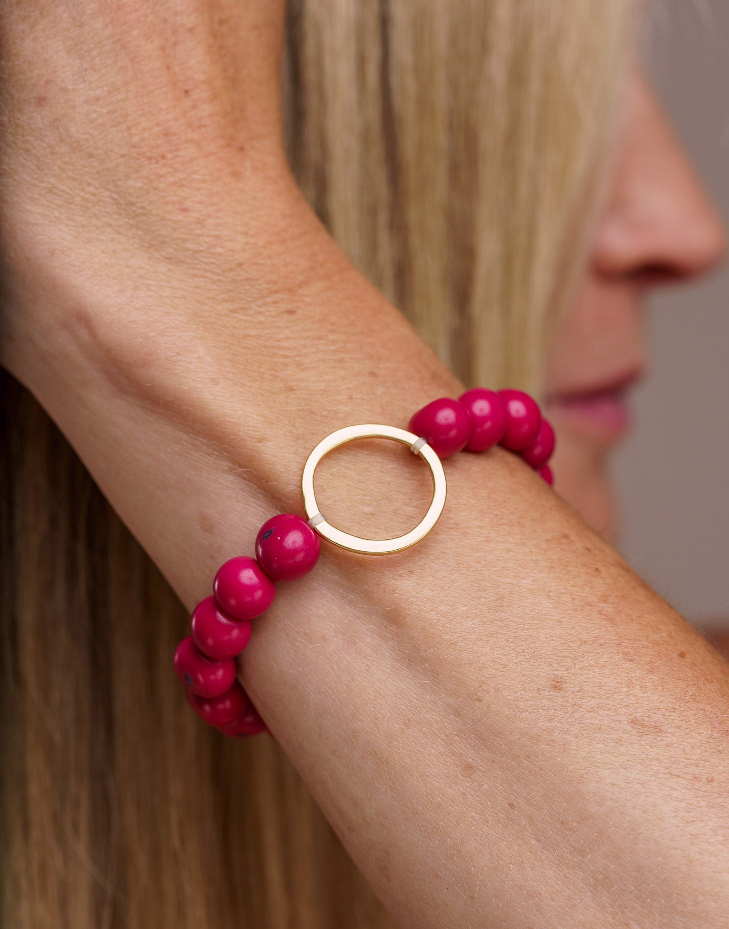 Argola Brass Acai Bracelet in Pink featuring organic Acai seeds and raw Brass hoop detail, showcasing a boho style.