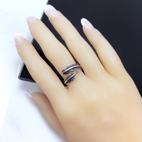 Ariel Feather Wrap Ring in sterling silver plating, featuring a unique feather design, adjustable fit, and a chic bohemian style.