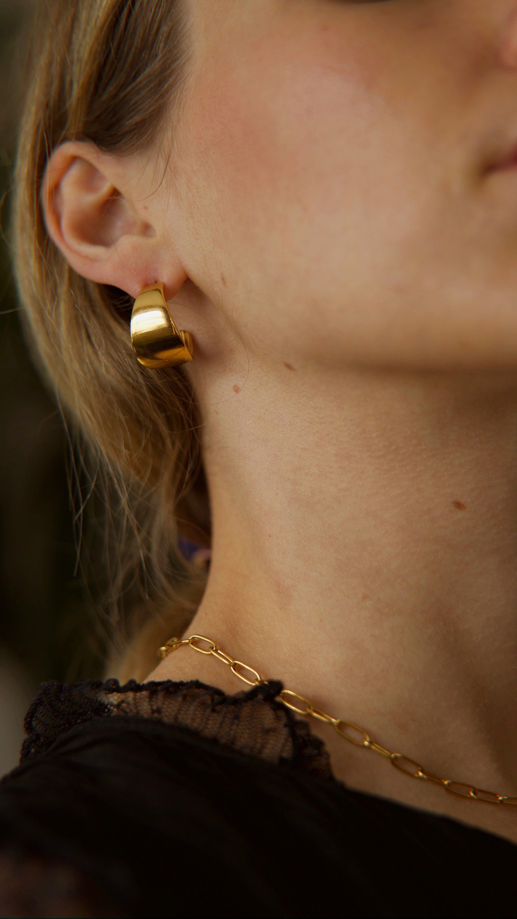 Ariel Luxurious Earrings featuring a bold hoop design in polished stainless steel with 18Kt yellow gold PVD plating.