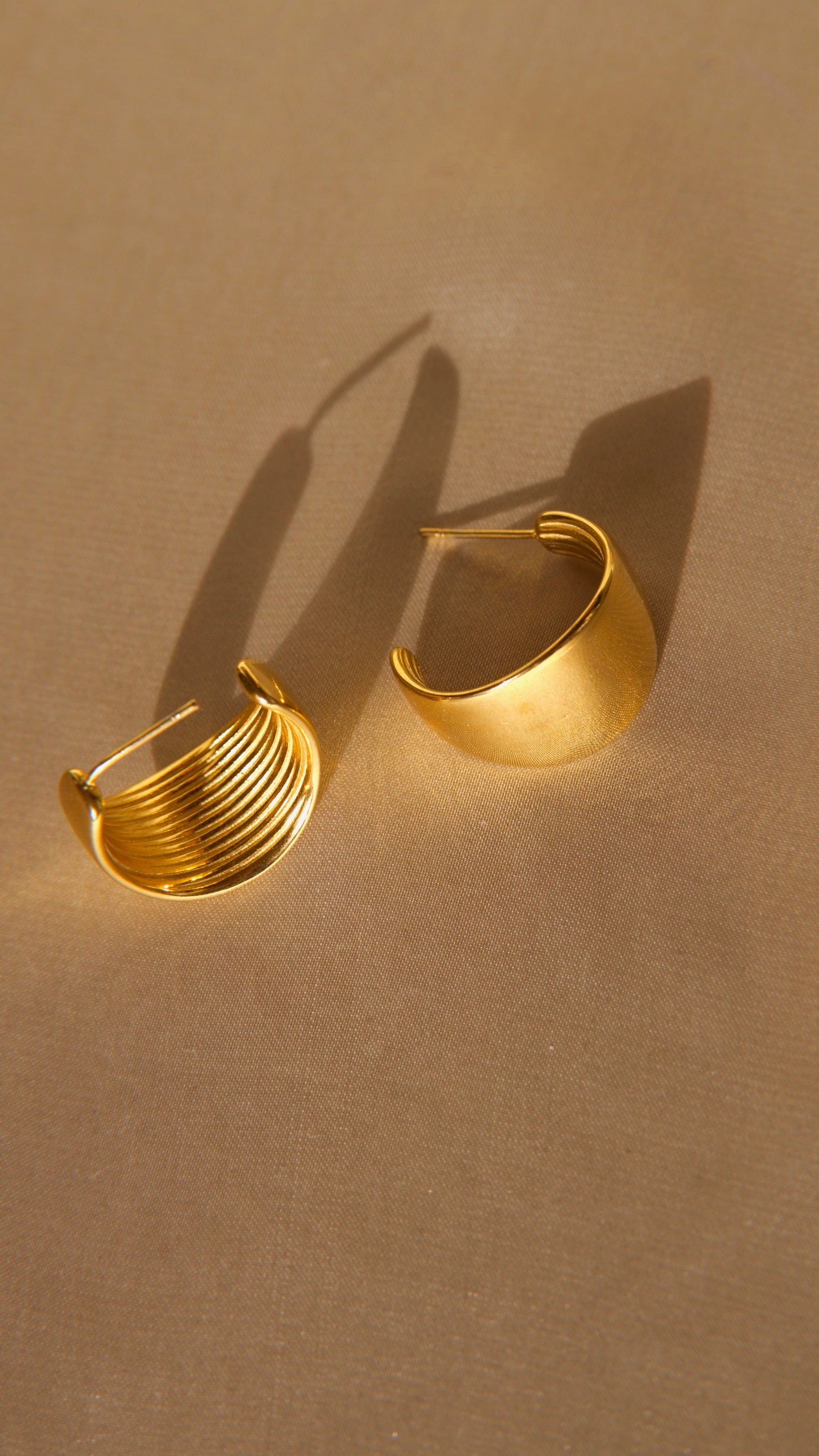 Ariel Luxurious Earrings featuring a bold hoop design in polished stainless steel with 18Kt yellow gold PVD plating.