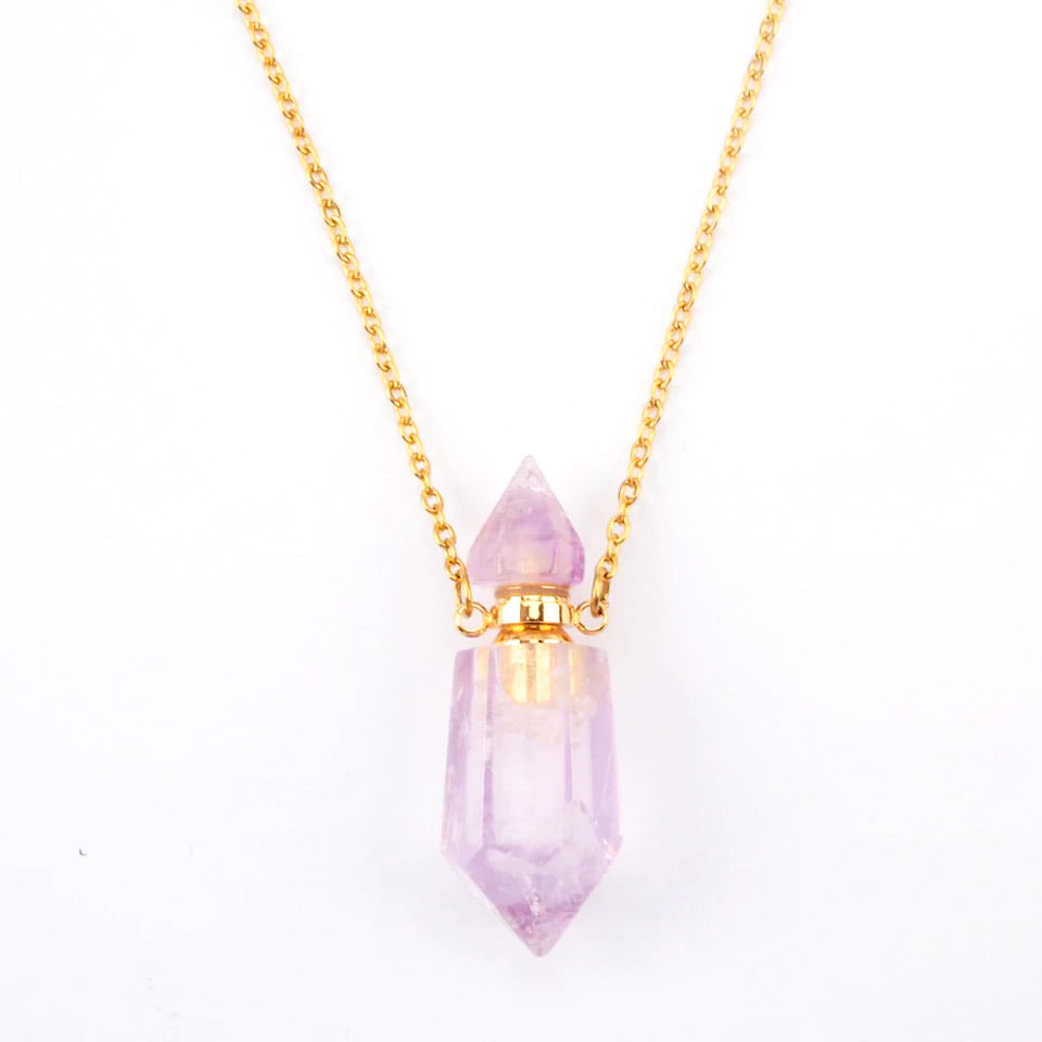 Aroma Gem Necklace featuring a crystal point pendant on an 18K gold plated chain, showcasing Amethyst, Clear Quartz, and Rose Quartz.