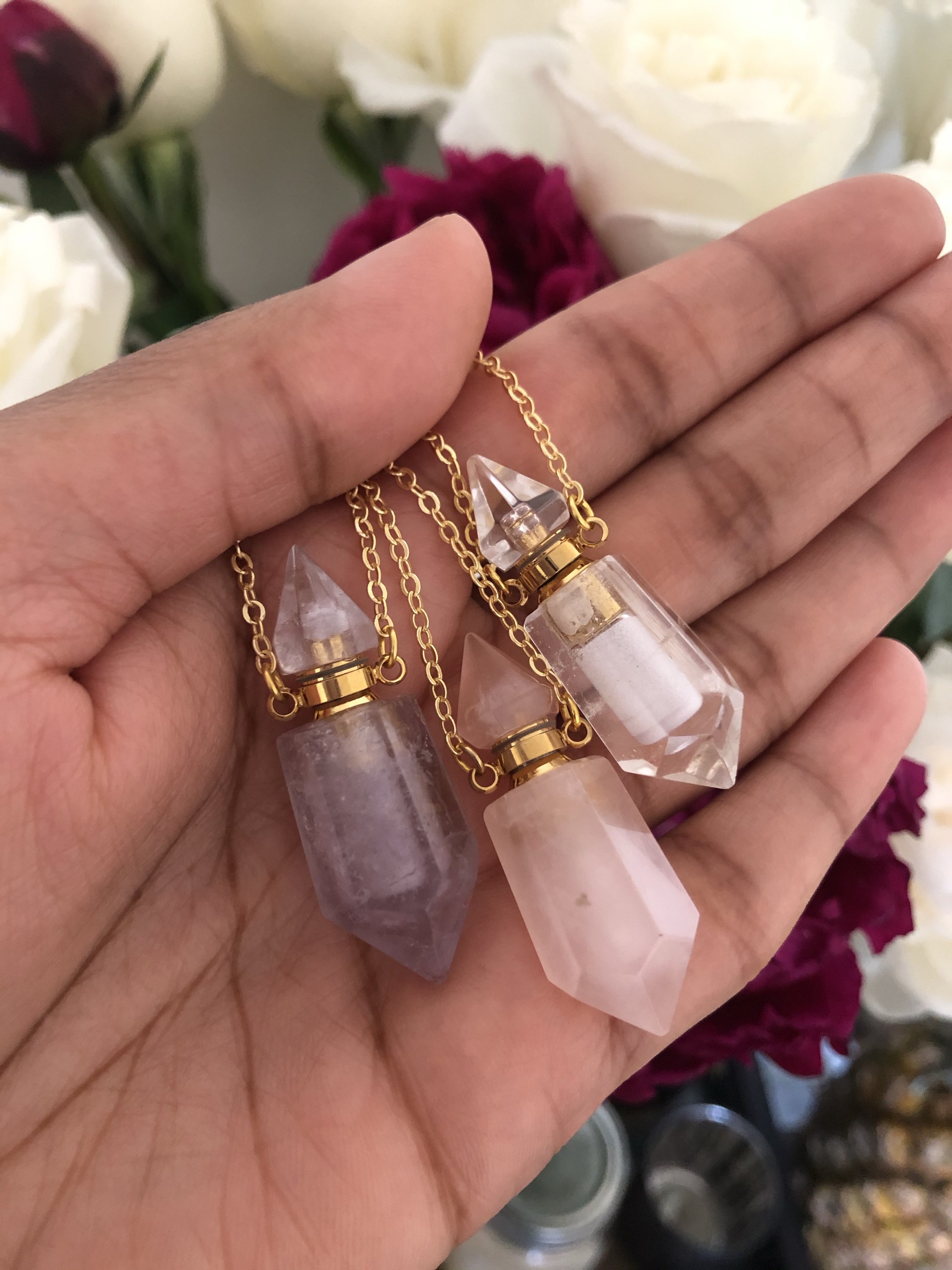 Aroma Gem Necklace featuring a crystal point pendant on an 18K gold plated chain, showcasing Amethyst, Clear Quartz, and Rose Quartz.