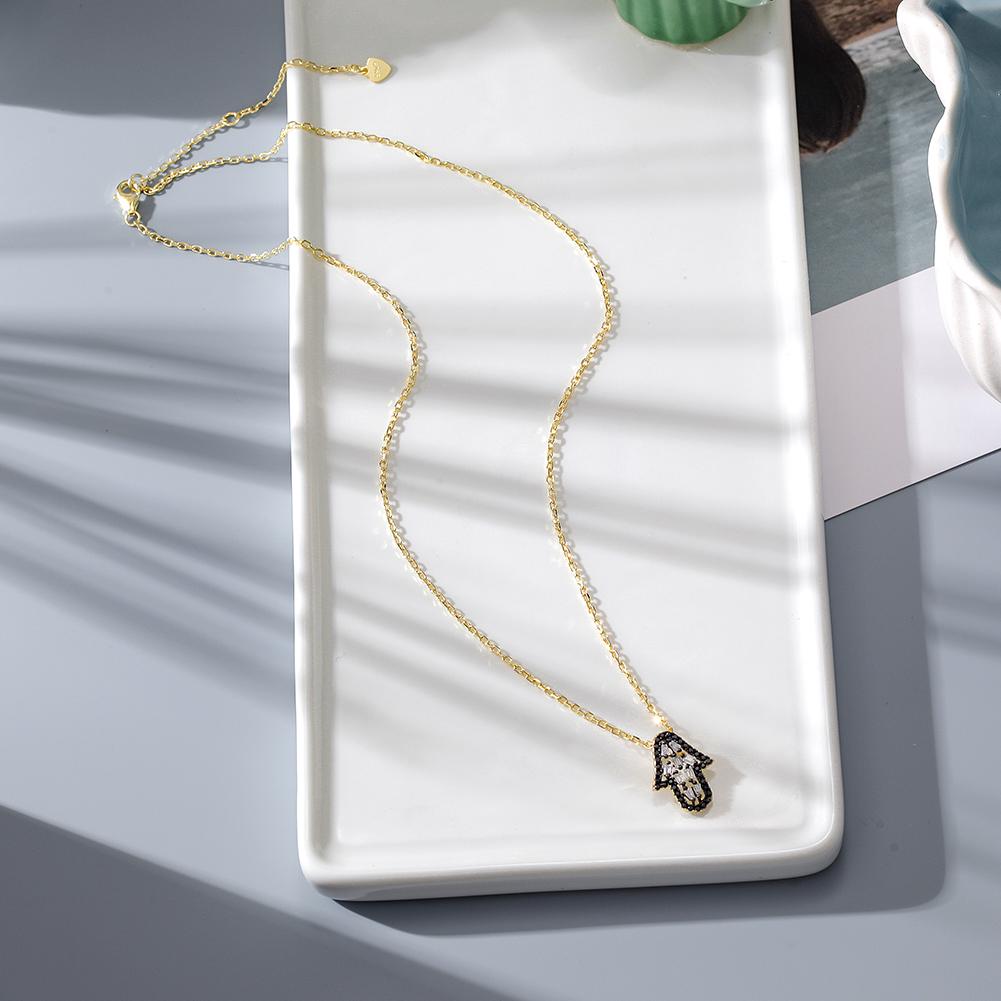 Elegant Arrowhead Pendant Necklace featuring CZ stones and a 14k gold chain, beautifully displayed in a gift box.