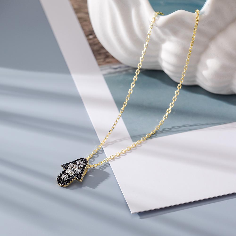 Elegant Arrowhead Pendant Necklace featuring CZ stones and a 14k gold chain, beautifully displayed in a gift box.