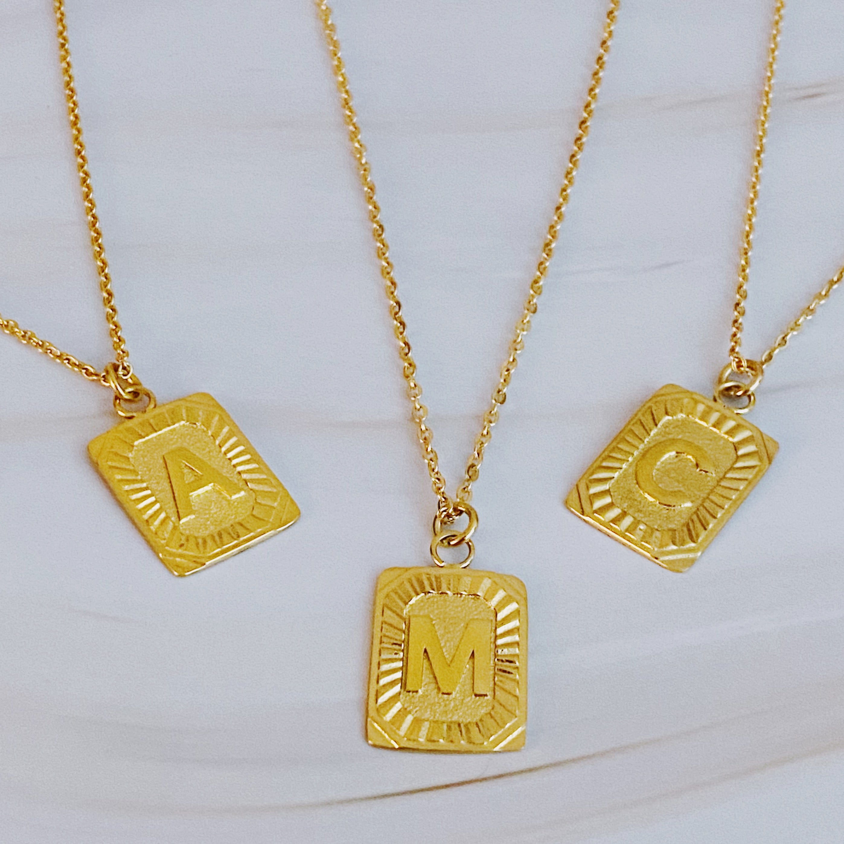 Art Deco Initial Necklace featuring a gold bar charm on a delicate chain, perfect for layering.