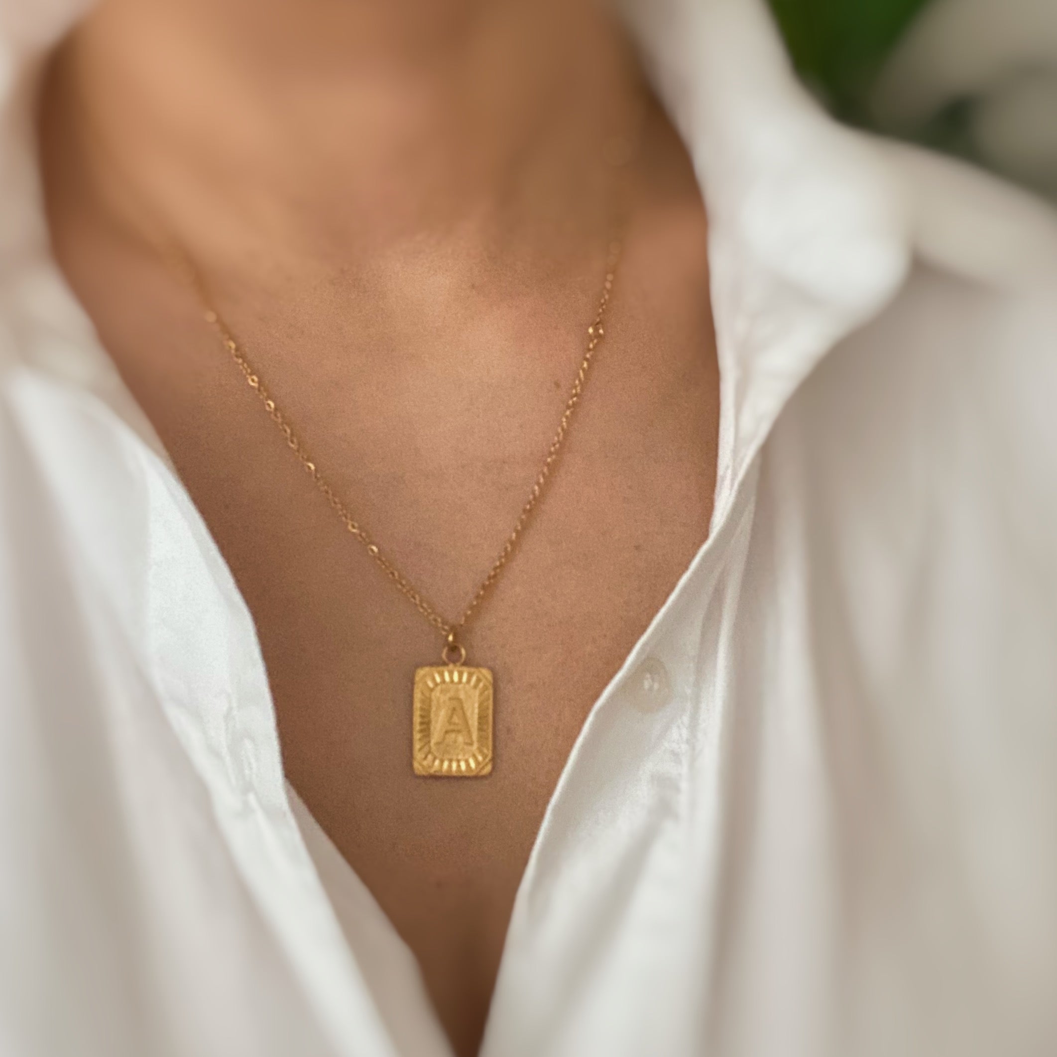 Art Deco Initial Necklace featuring a gold bar charm on a delicate chain, perfect for layering.