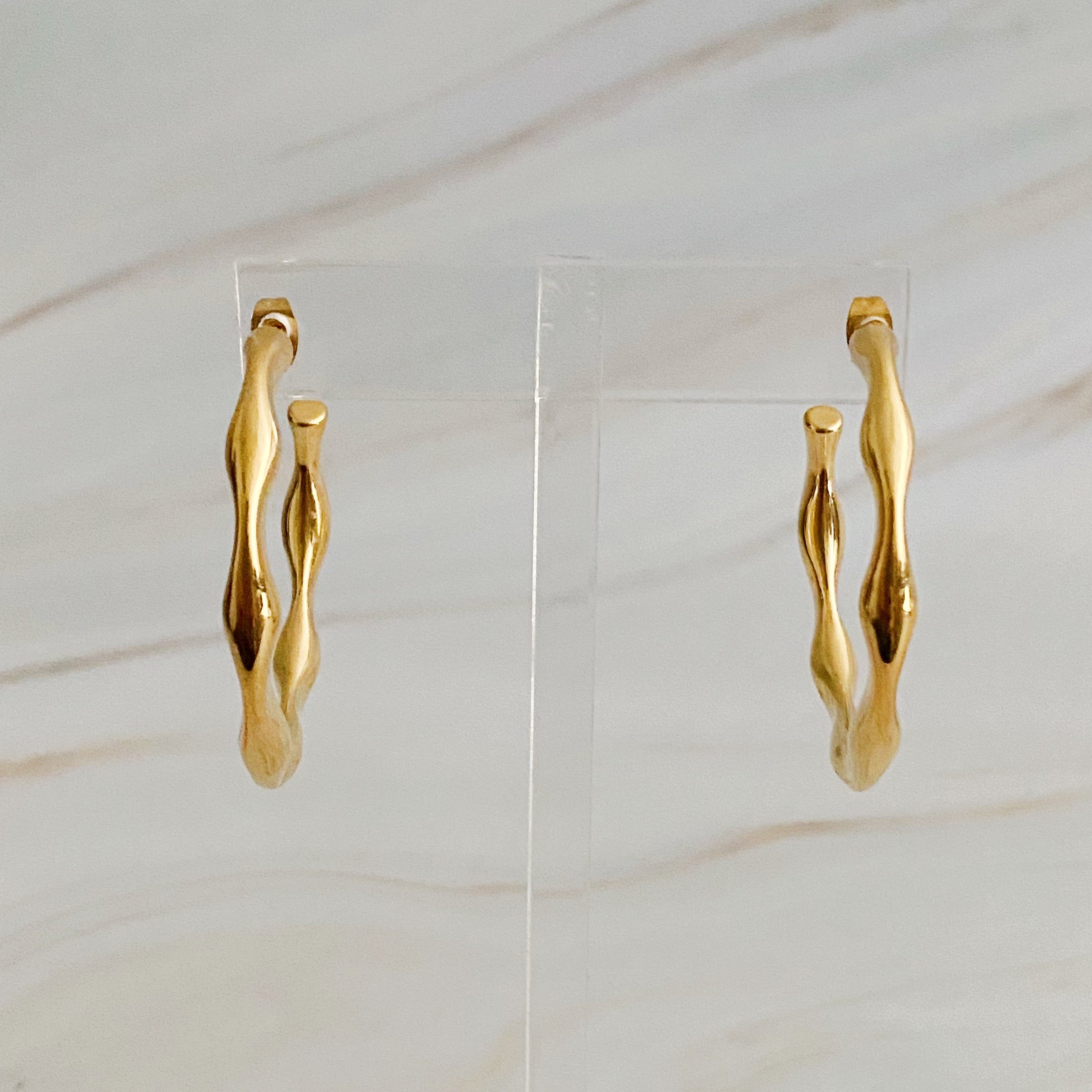 Art In Hoop Earrings featuring a sleek modern design with a unique molten texture, crafted from 18k gold plated stainless steel.