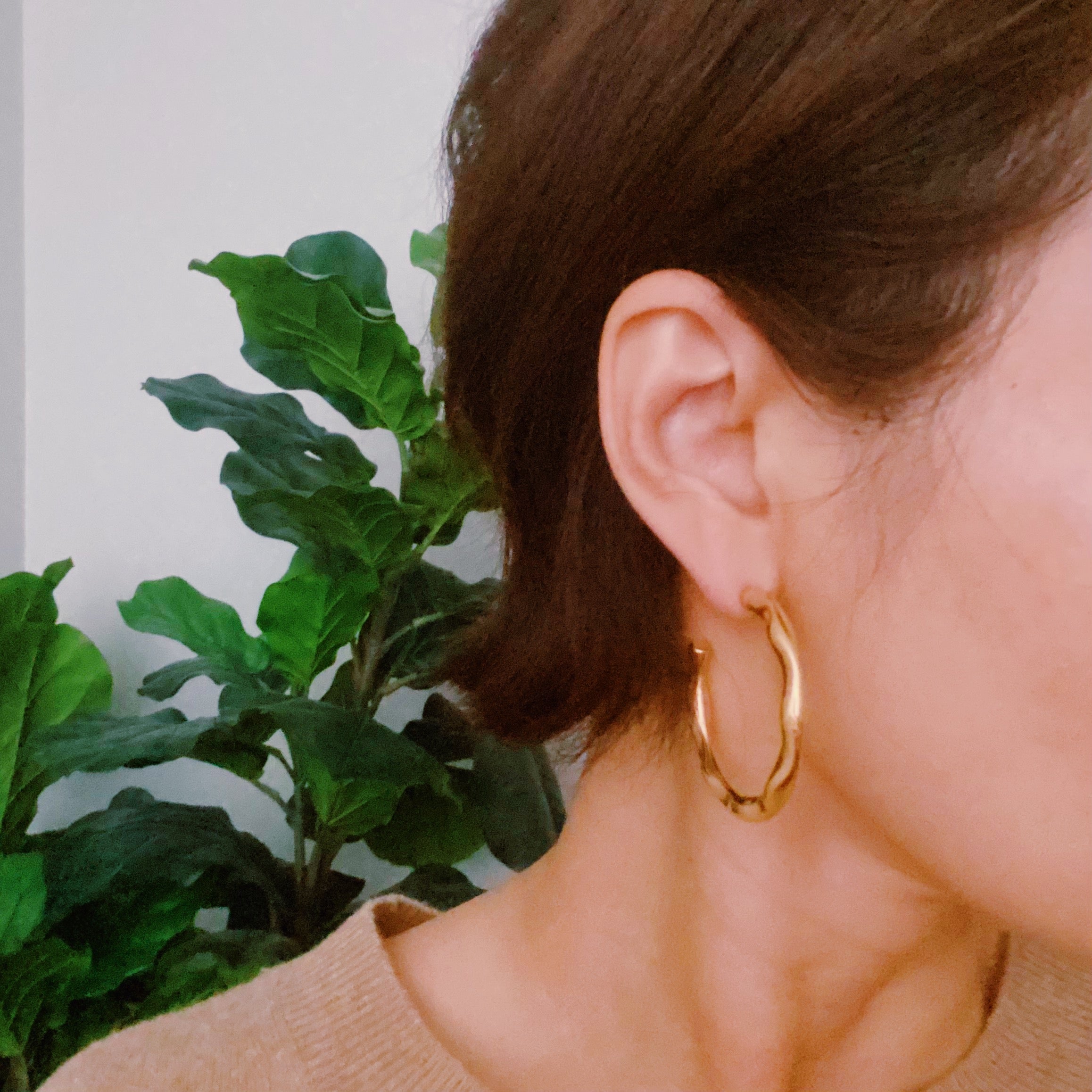 Art In Hoop Earrings featuring a sleek modern design with a unique molten texture, crafted from 18k gold plated stainless steel.