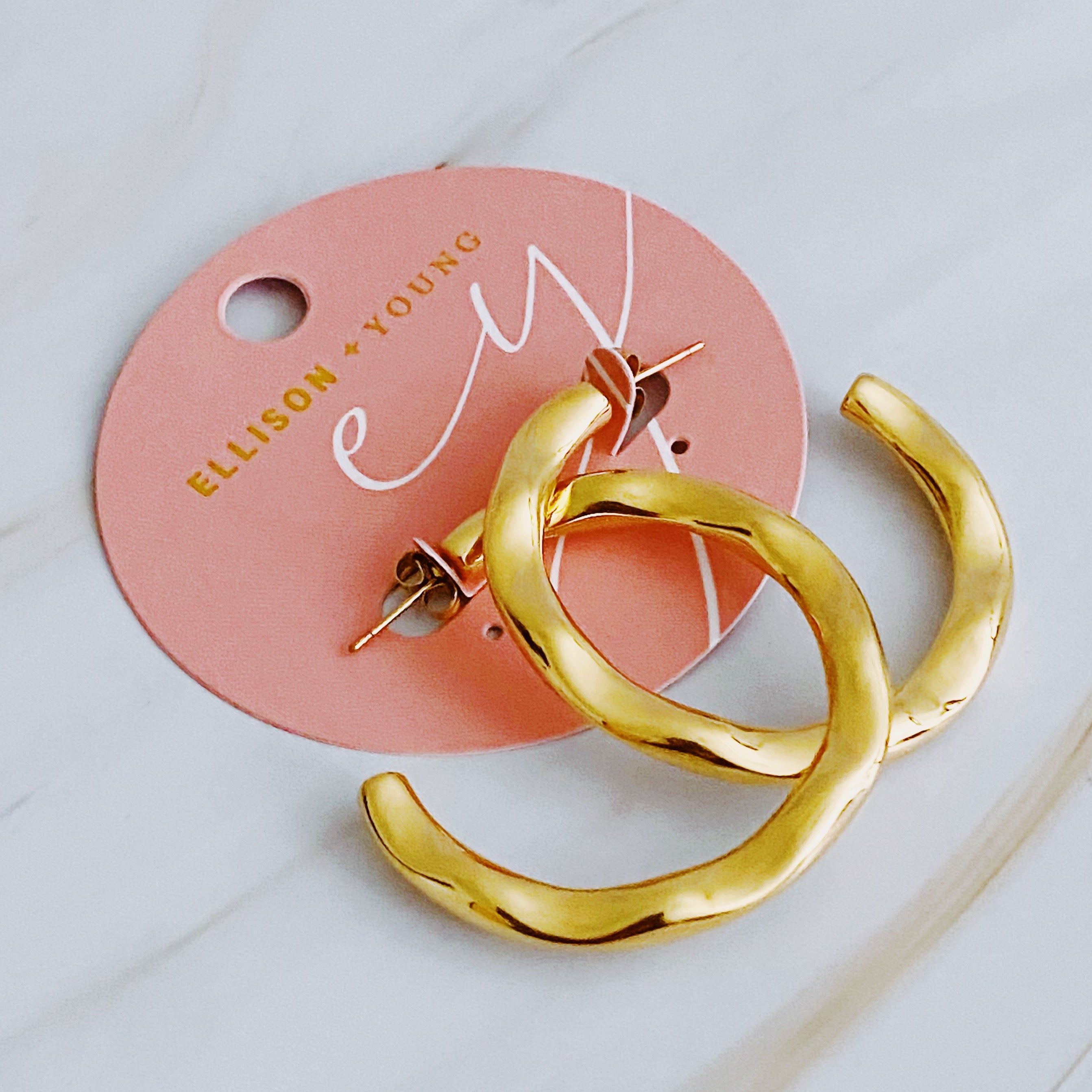 Art In Hoop Earrings featuring a sleek modern design with a unique molten texture, crafted from 18k gold plated stainless steel.