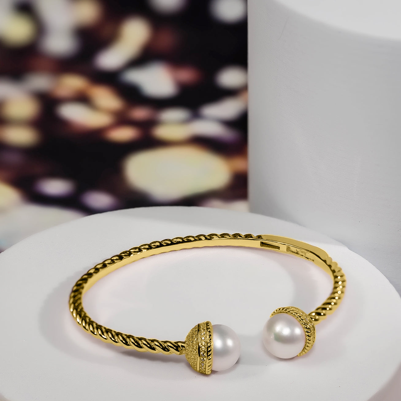 Asian Civilisations Museum Freshwater Pearl Bracelet with two lustrous pearls and a gold-plated sterling silver design, showcasing a spiral shape.