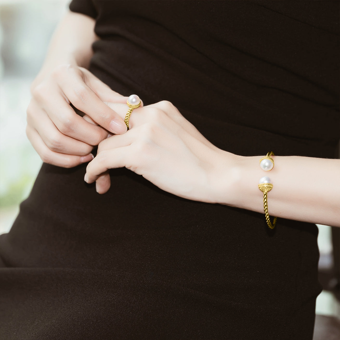 Asian Civilisations Museum Freshwater Pearl Bracelet with two lustrous pearls and a gold-plated sterling silver design, showcasing a spiral shape.