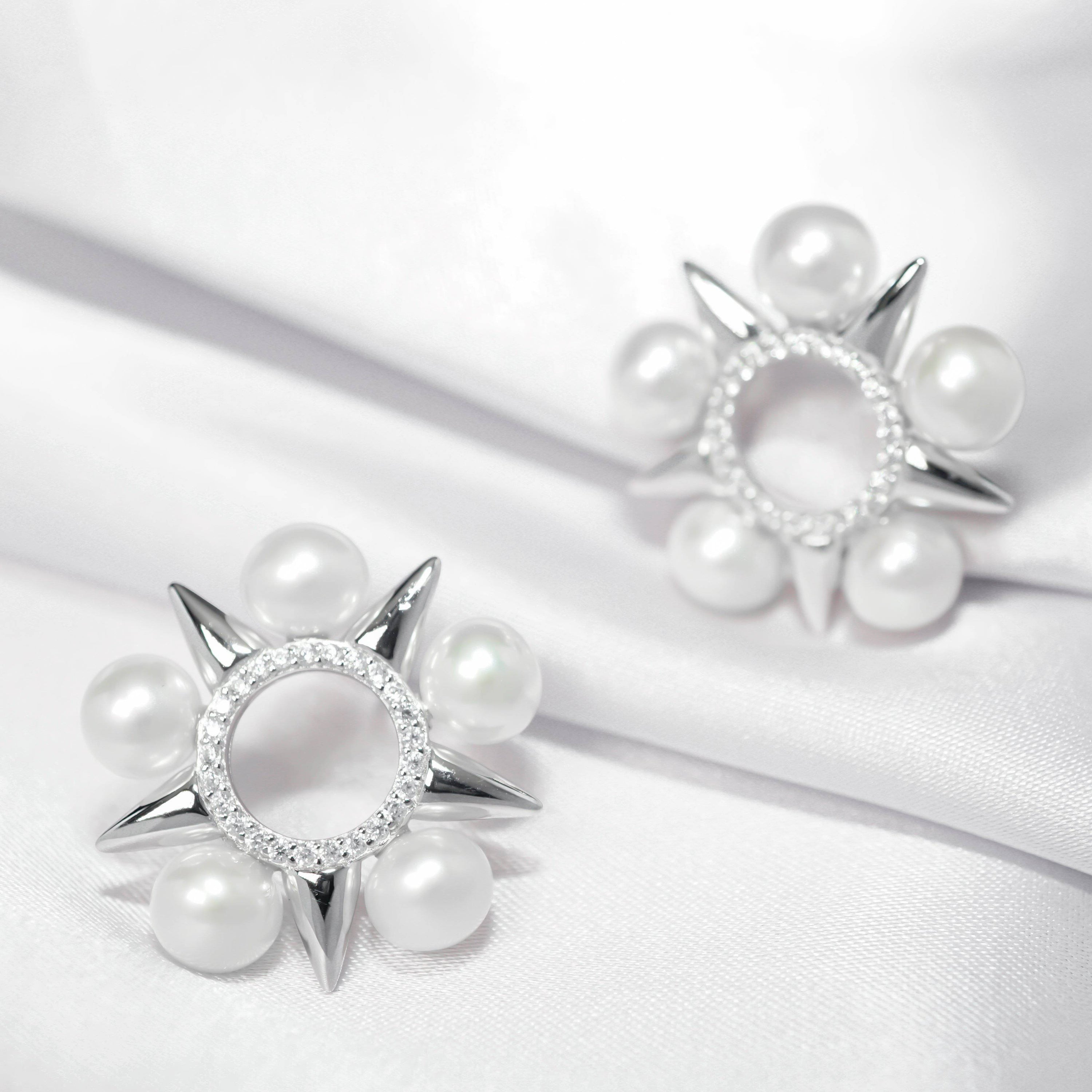 Asian Civilisations Museum Freshwater Pearl Earrings featuring a five-point star design with lustrous pearls and sterling silver.