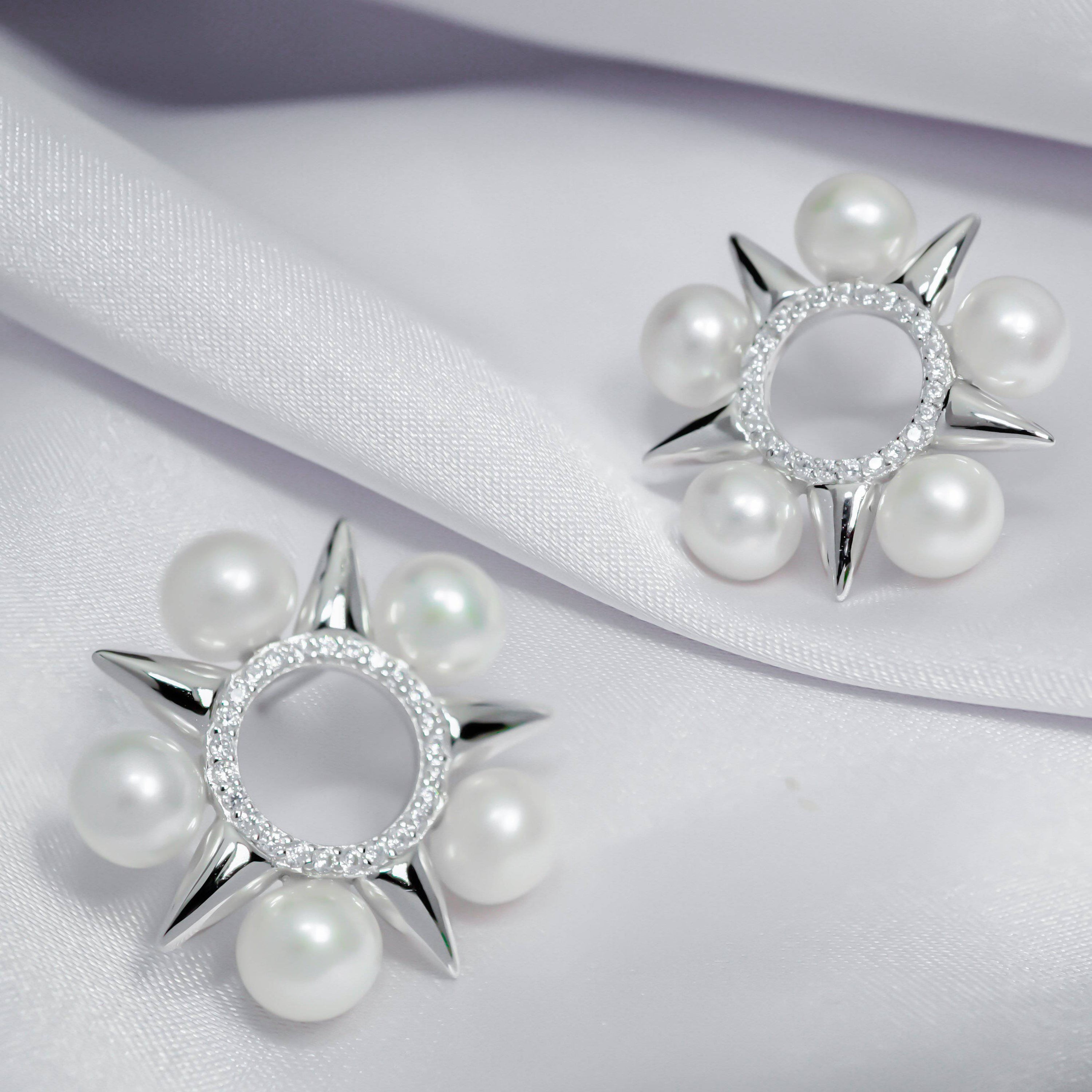 Asian Civilisations Museum Freshwater Pearl Earrings featuring a five-point star design with lustrous pearls and sterling silver.