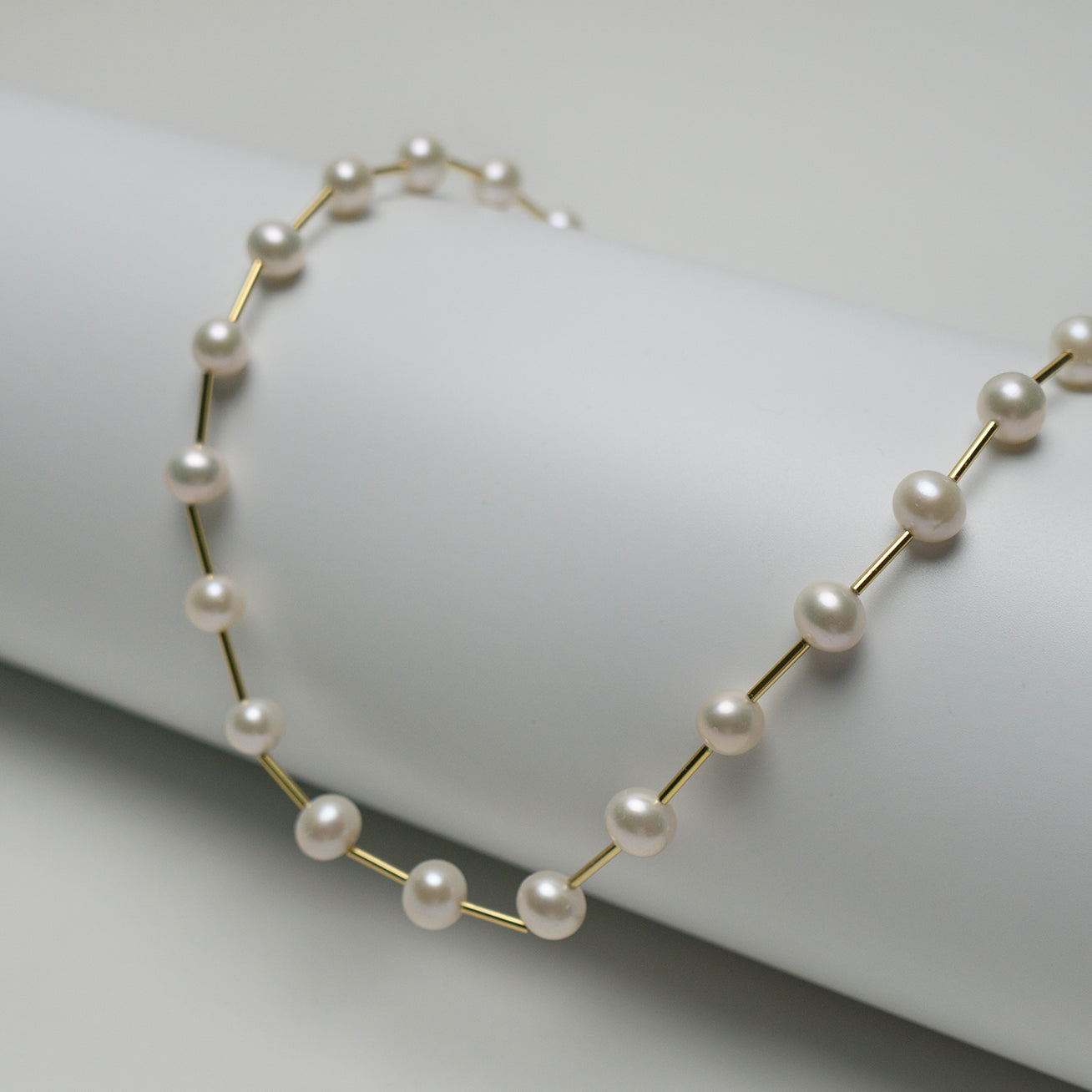 Asian Civilisations Museum Freshwater Pearl Necklace featuring lustrous white pearls and elegant spiral design in sterling silver with gold plating.