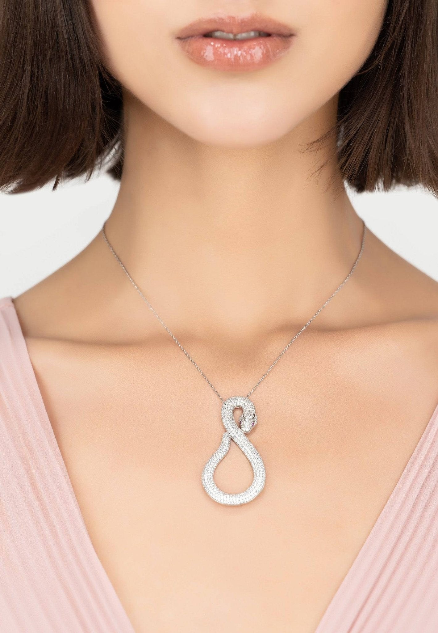 Asp Snake Pendant Necklace in silver and white with sparkling zircons, featuring a snake motif and adjustable length.