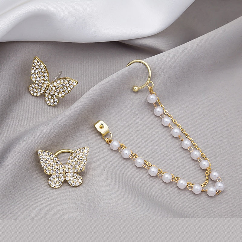 Asymmetric butterfly earring featuring a pearl ear clip, crafted from alloy, showcasing a unique design.