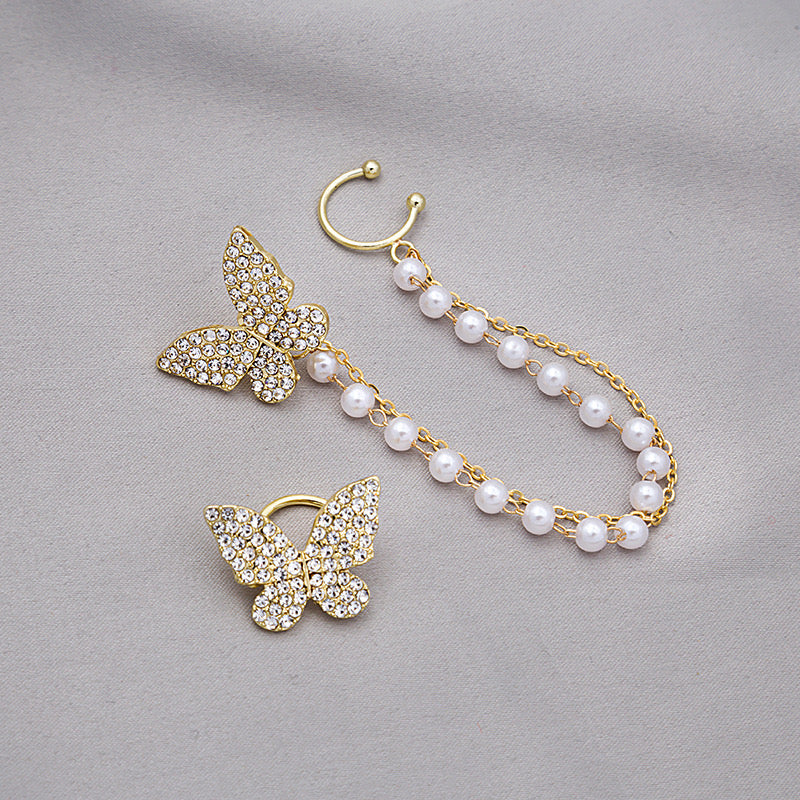 Asymmetric butterfly earring featuring a pearl ear clip, crafted from alloy, showcasing a unique design.