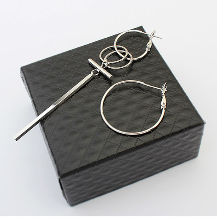 A pair of stylish asymmetric hoops and stick earrings made from alloy, showcasing a modern design with a unique shape.