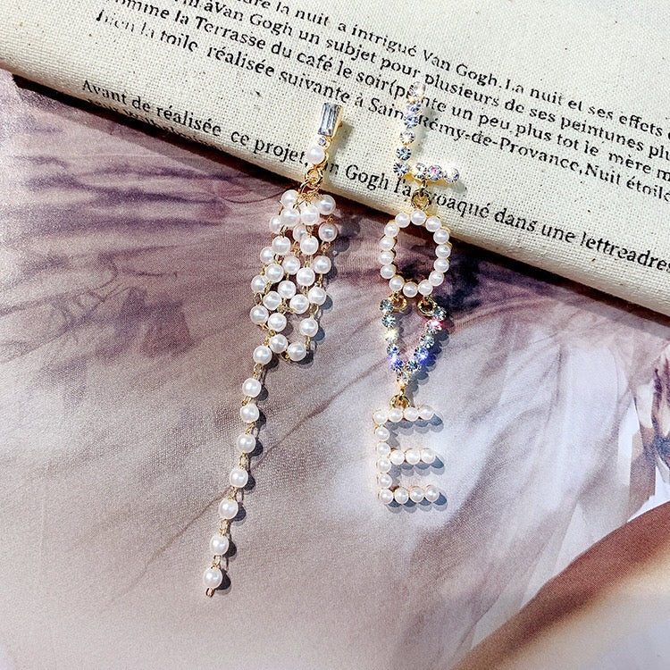 Elegant Asymmetric Love Pearl Earrings featuring alloy, rhinestones, and pearls, showcasing a unique design.