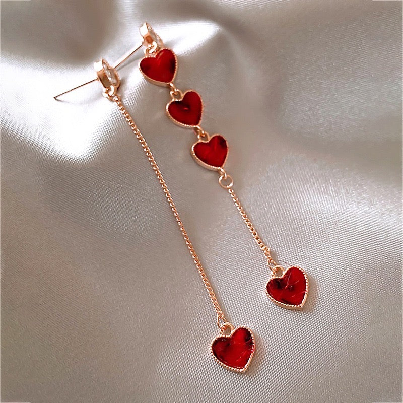 Asymmetric long earrings featuring red heart designs with rhinestones, crafted from alloy and S925, showcasing a modern and elegant style.